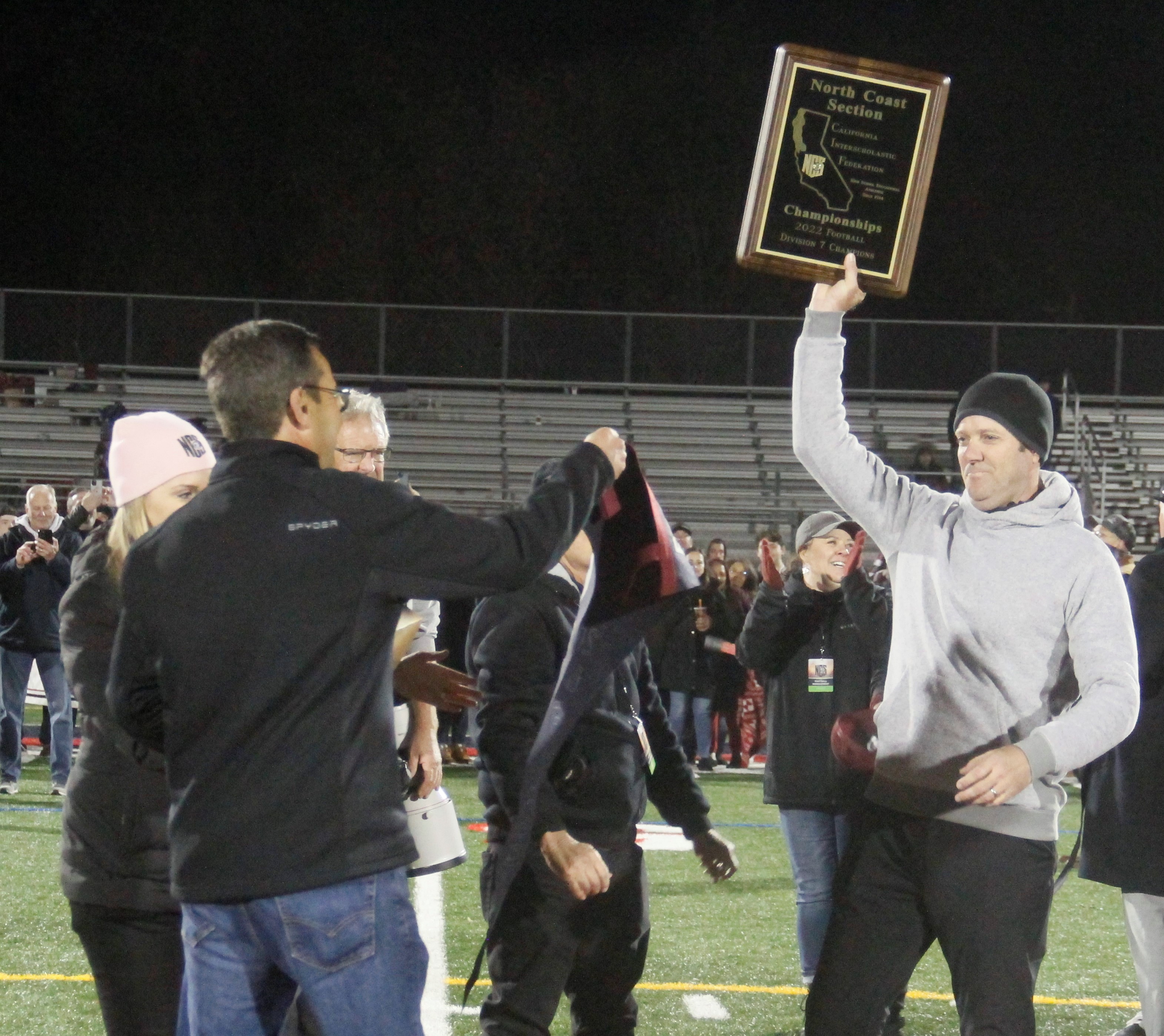 Clear Lake head coach Mark Cory hoists the section championship plaque during the awards ceremony Saturday night following the Cardinals' 56-55 come-from-behind win over St. Vincent, a victory that puts his team in the regional round of the CIF State Playoffs next weekend. (Photos by Minenna Photography)