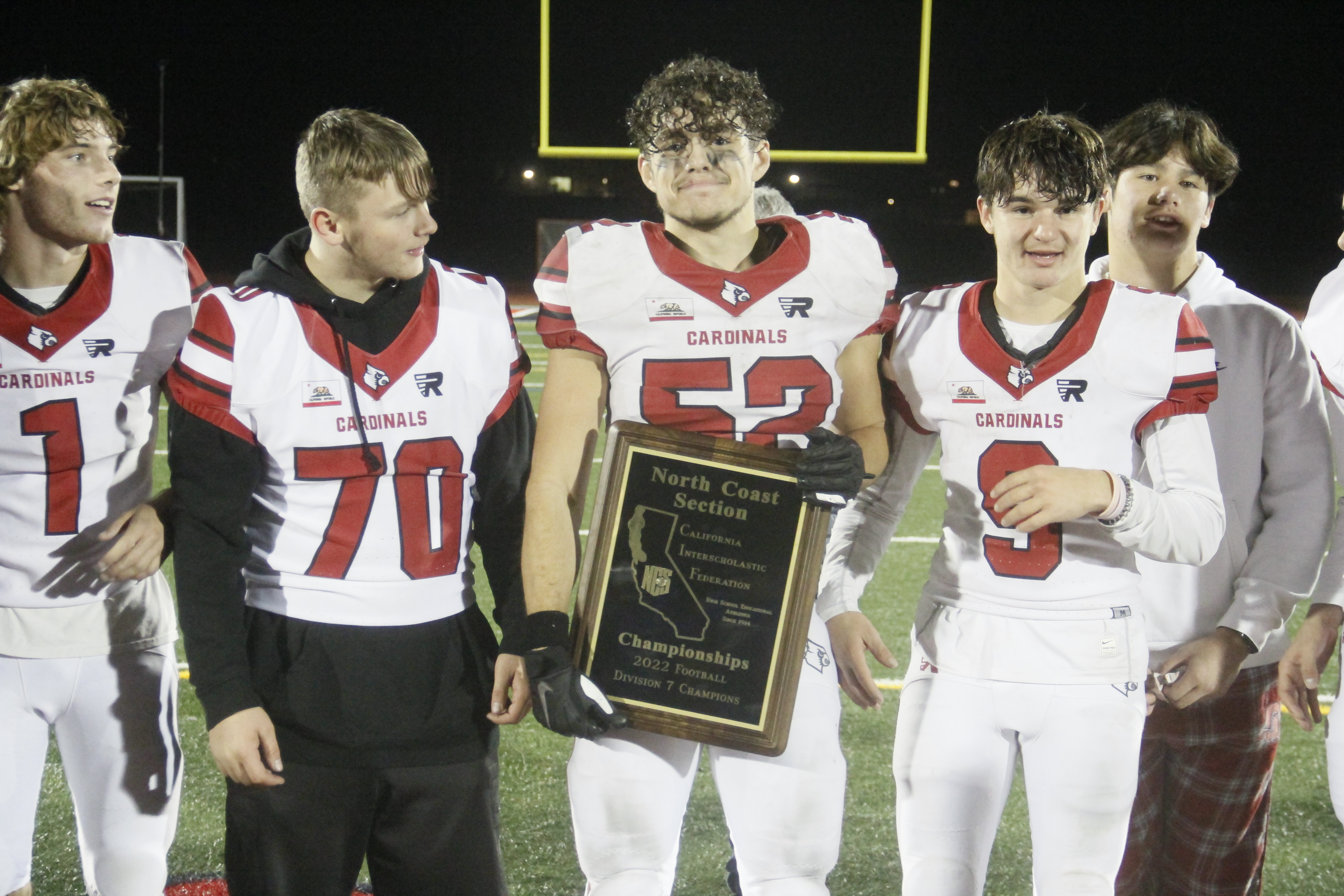 Clear Lake's Tony Gersalia poses with the North Coast Section championship plaque following the Cardinals' 56-55 shootout win with previously undefeated St. Vincent. (Photos by Minenna Photography)