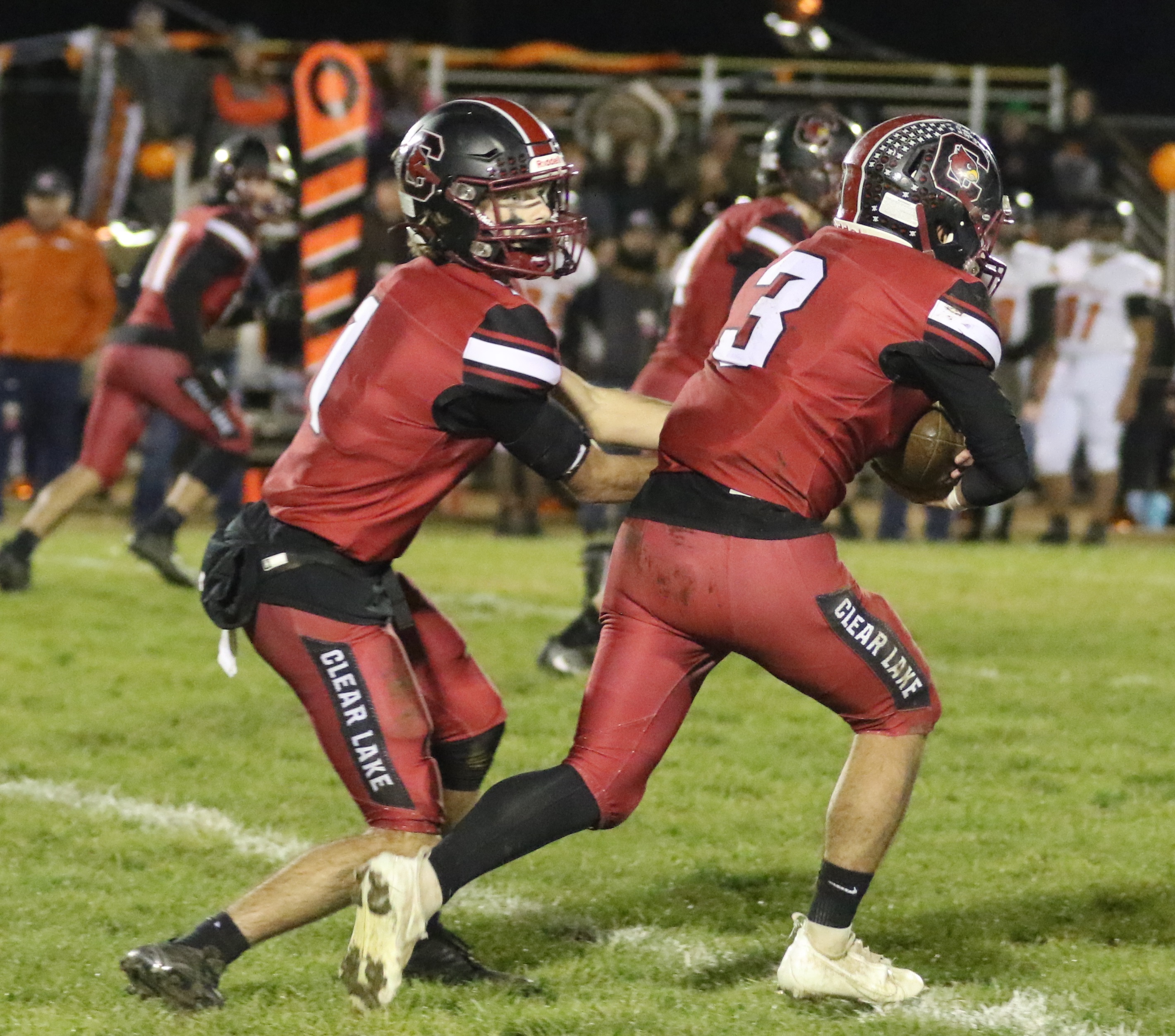 Clear Lake quarterback Jake Soderquist hands the ball off to running back Hank Ollenberger, who had another big night for the Cardinals with 106 rushing yards and two touchdowns in a 28-22 semifinal-round playoff win over Kelseyville. (Photos by Minenna Photography)