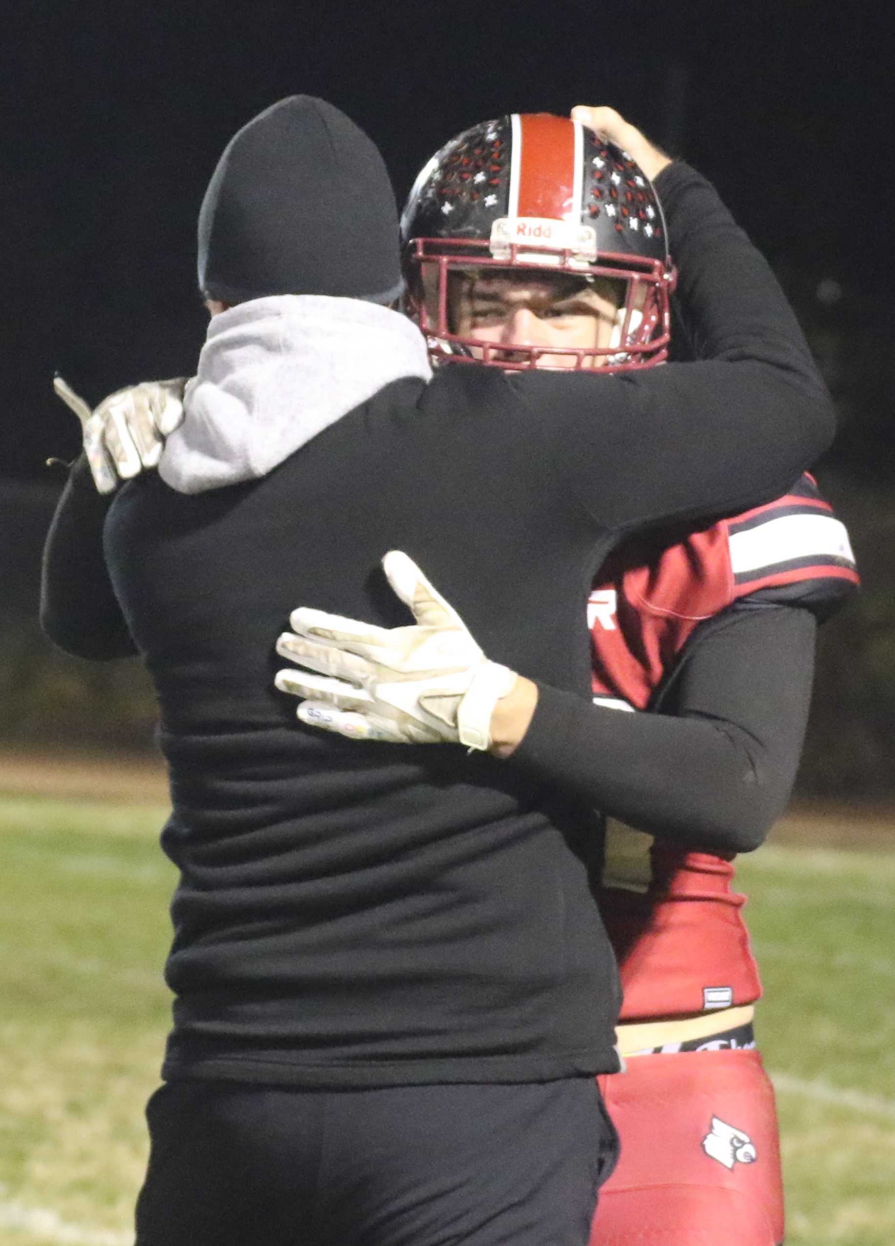 Clear Lake head coach Mark Cory hugs one of his players following the Cardinals' 28-22 playoff win over Kelseyville, a victory that moves the team into the Division 7 championship game next weekend. (Photos by Minenna Photography)