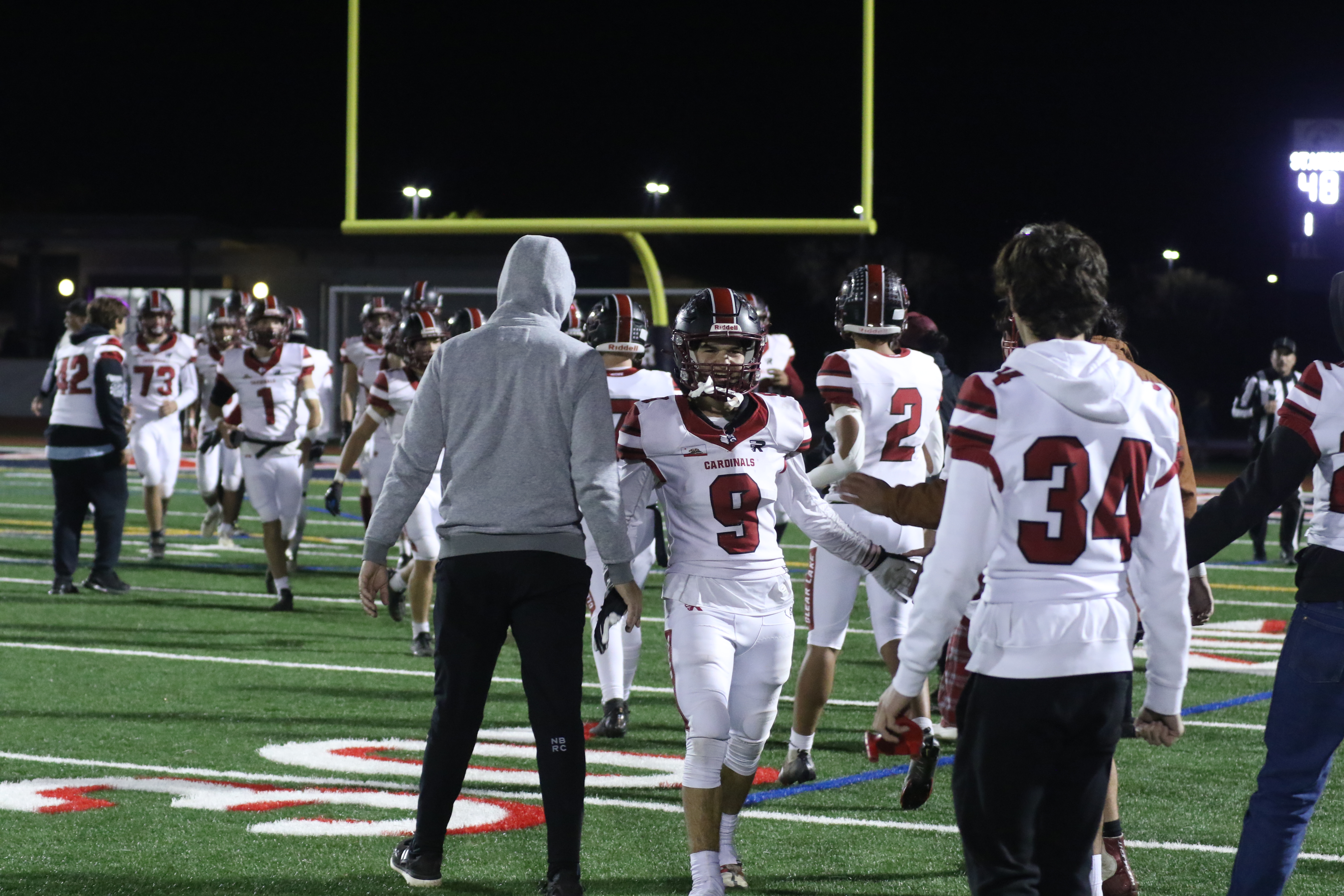 Jesse Hayes (9) greets head coach Mark Cory near the sidelines following a Clear Lake touchdown scored by teammate Ayden Williamson in the third quarter. (Photos by Minenna Photography)