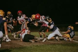 Middletown's Oscar Cruz brings down St. Helena running back Sam Raunegger during Friday's action in Middletown. (Photos courtesy of Geri Costlow)