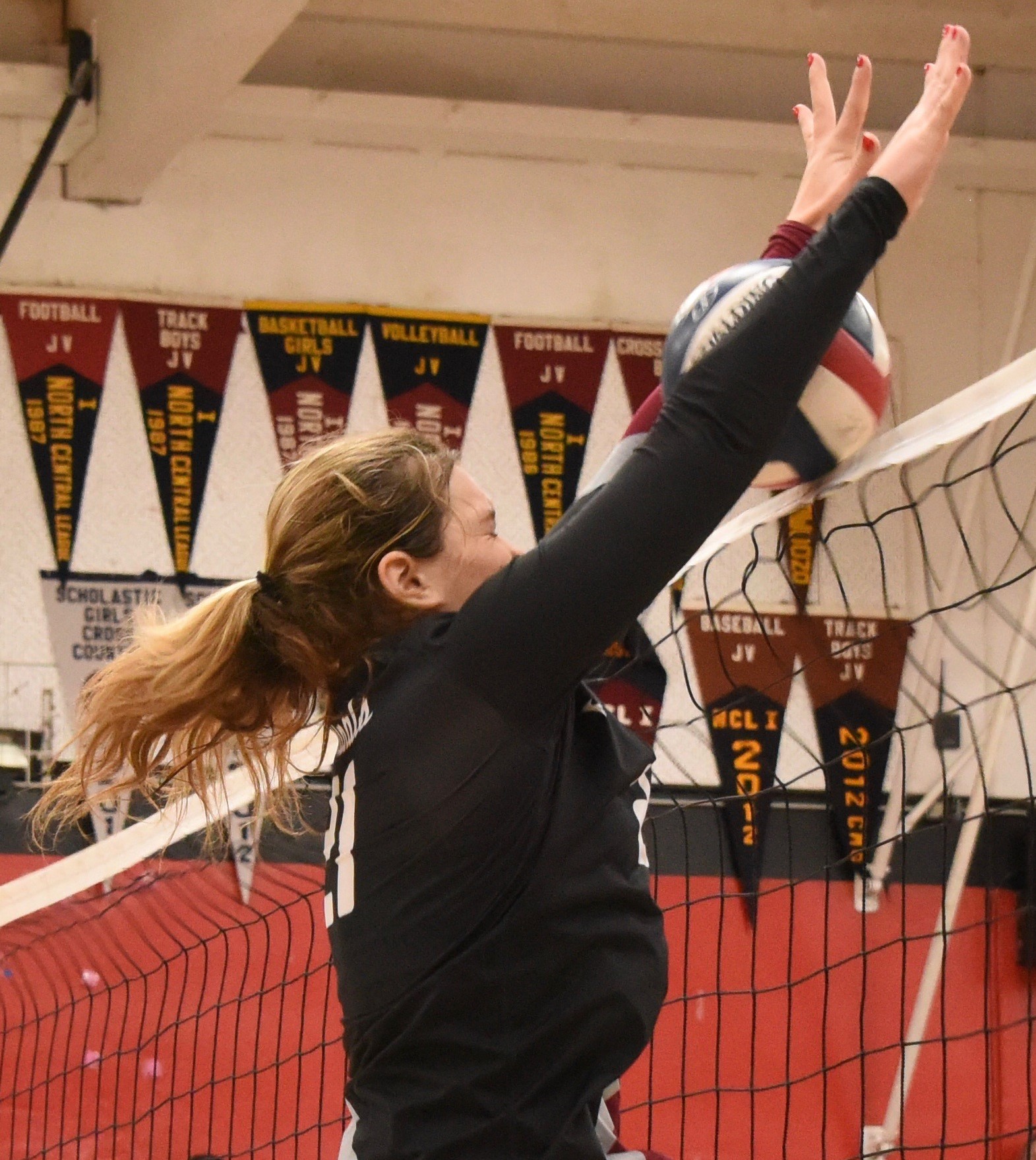 Clear Lake's Abby Mertle tries for the block during action against The Bay School. Mertle led the Cardinals with four blocks. (Photos courtesy of Trett Bishop)