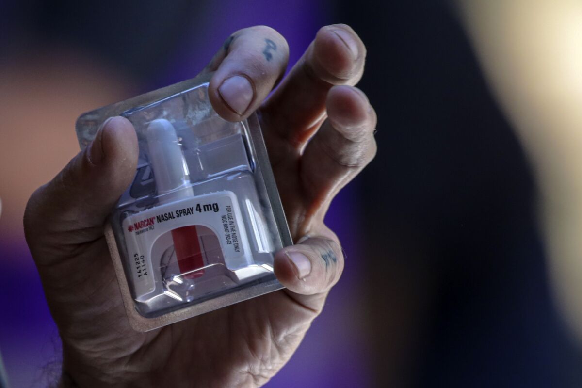 Spider Davila, from L.A. Community Health Project, talks about how to use Narcan at an event marking International Overdose Awareness Day outside Los Angeles City Hall in August. (Photo: Irfan Khan/Los Angeles Times)