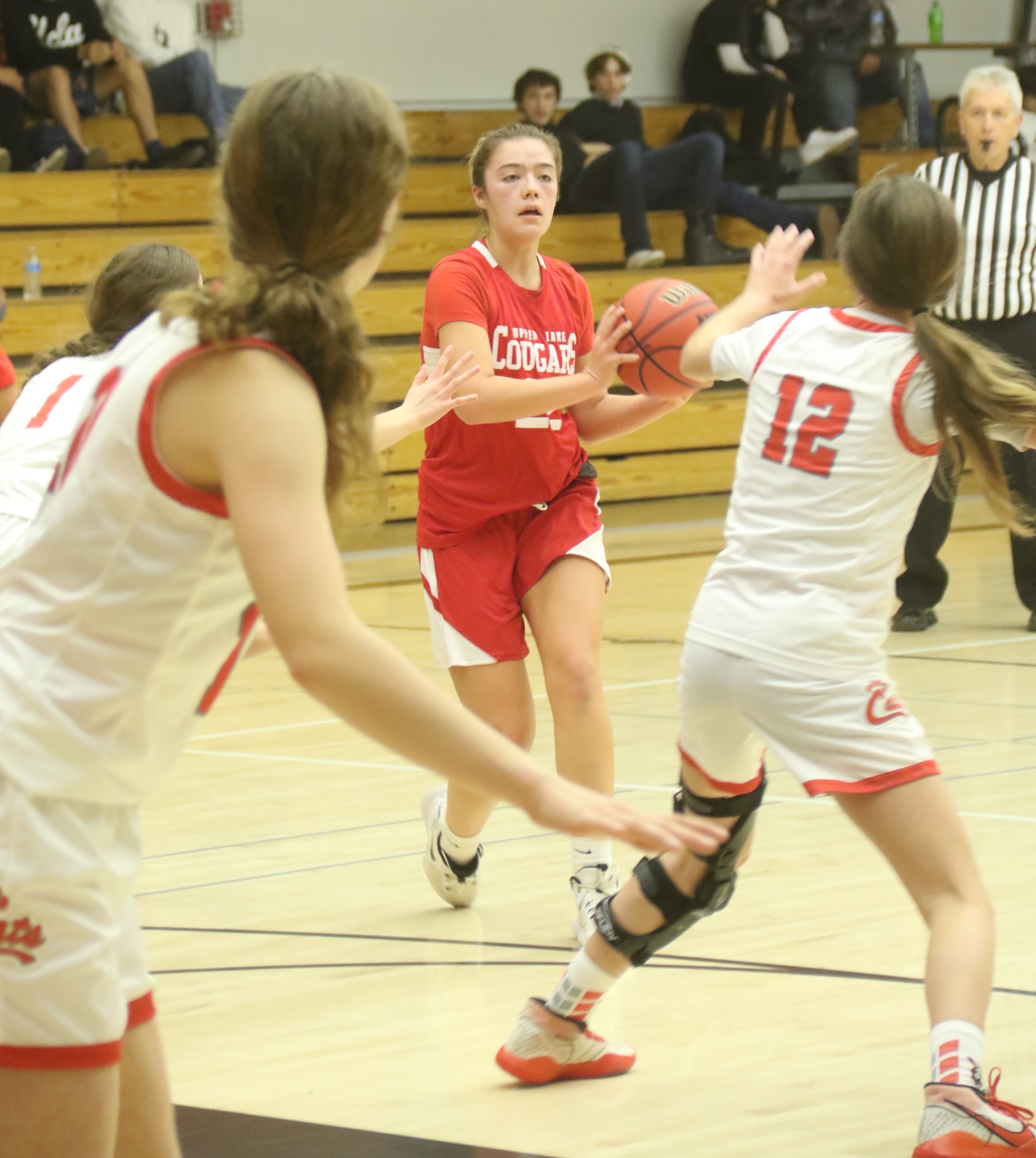 Upper Lake's Nya Marcks looks for an opening in the Ferndale defense Friday night in Kelseyville. Standing in her way is the Wildcats' Carly Carmesin (12). Ferndale beat Upper Lake 54-38. (Photos by Bob Minenna)