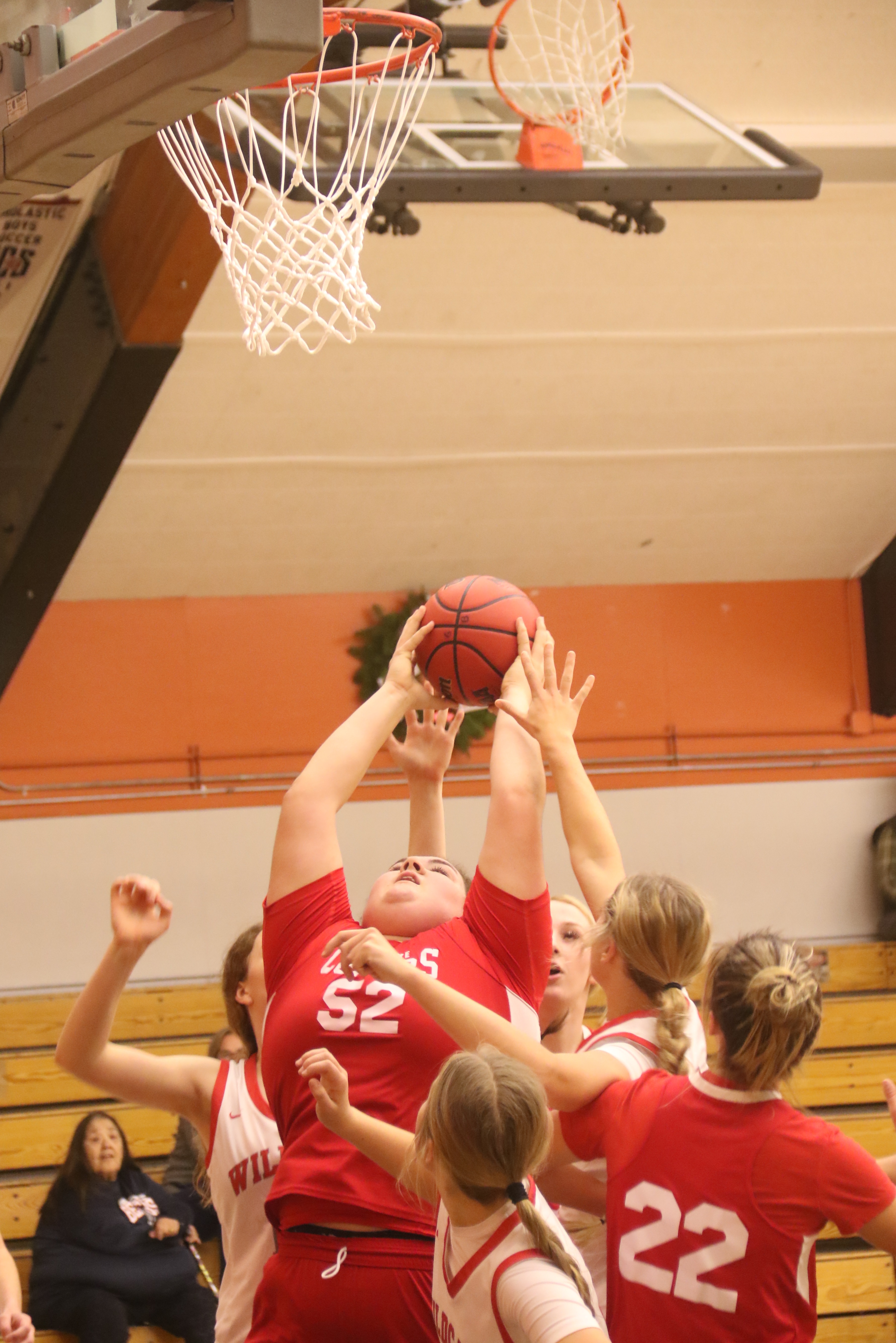 Upper Lake's Taylar Minnis comes down with the rebounds a teammate Nya Marks and a host of Ferndale players look on.