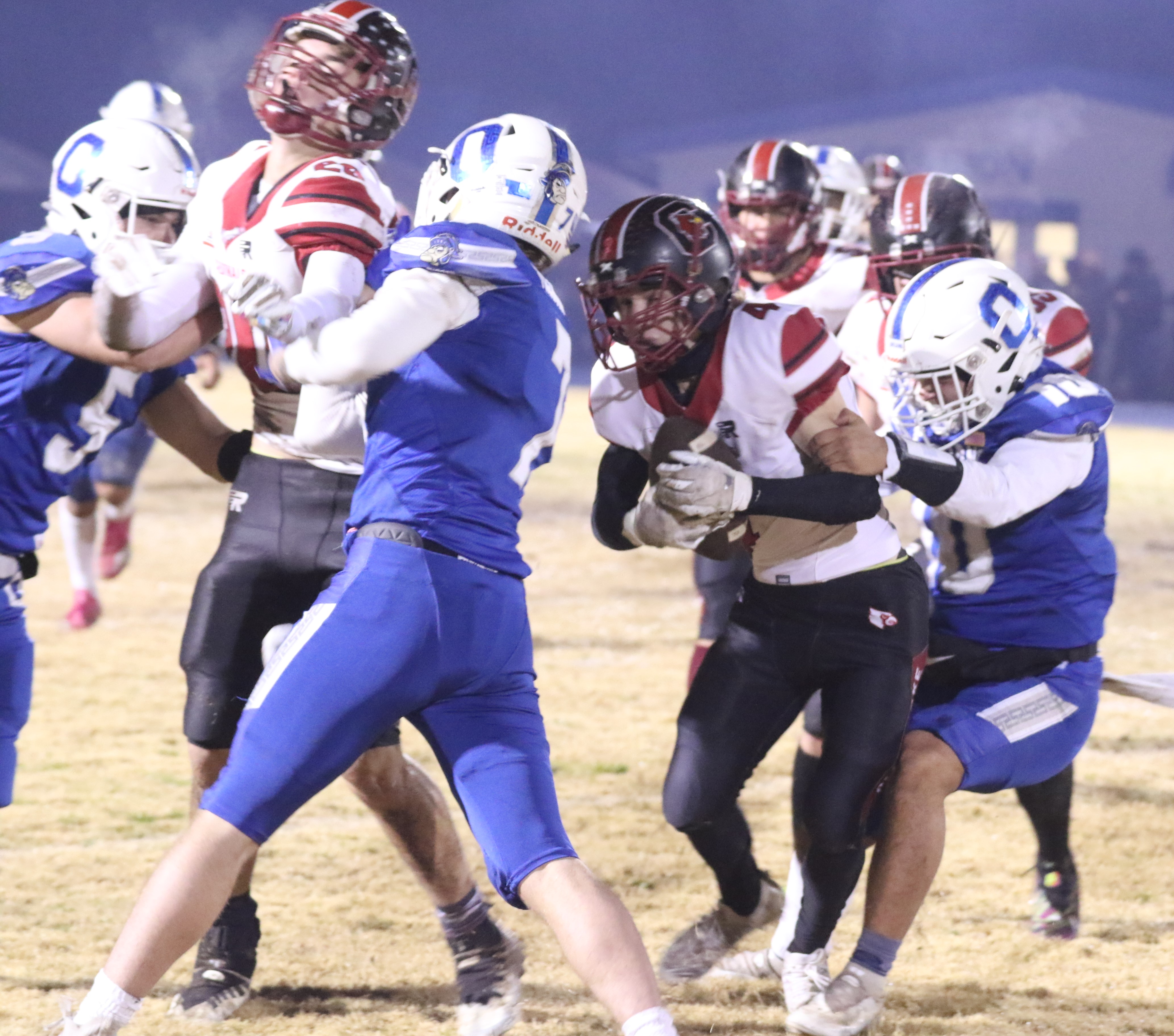 Clear Lake wide receiver Ayden Williamson (4) is grabbed from behind after hauling in a pass Saturday night against Orland in the 5-A NorCal championship game at Orland High School. (Photos by Minenna Photography)