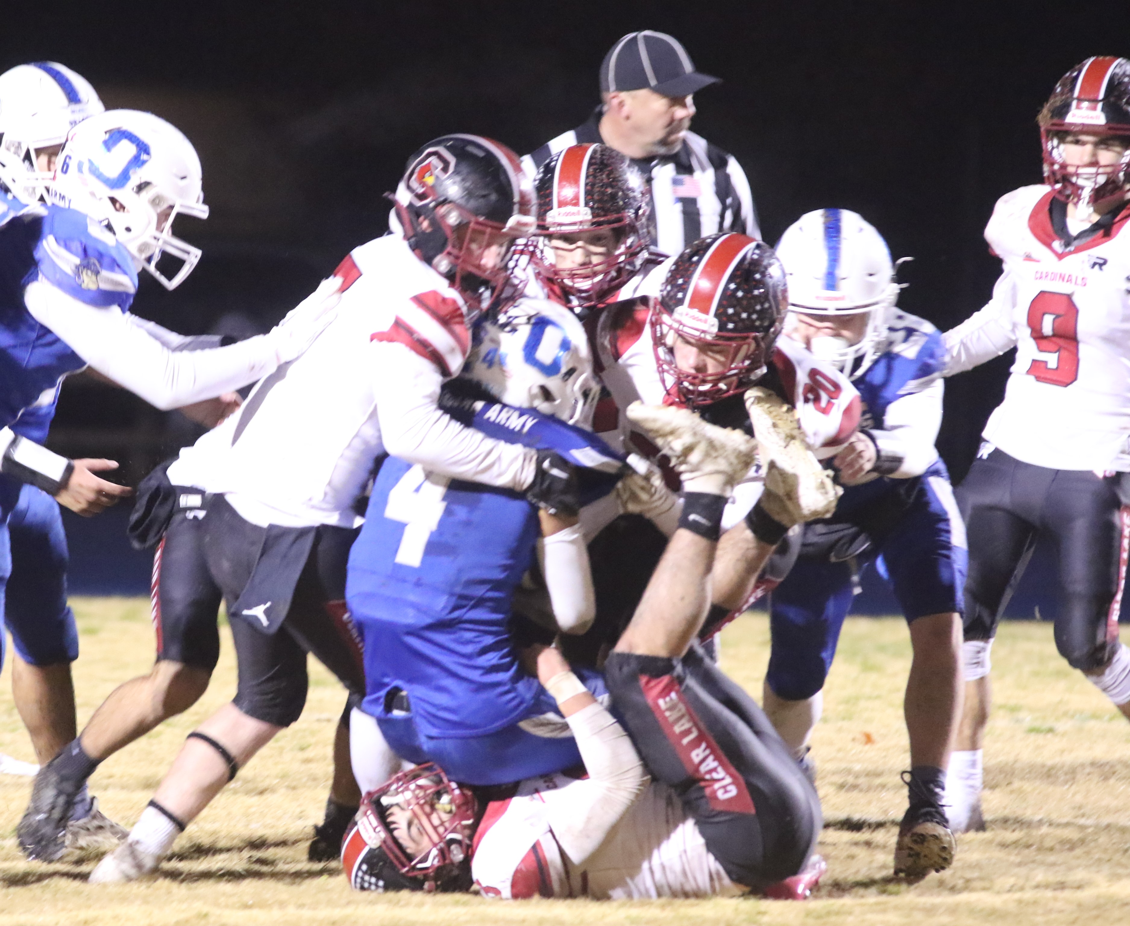Orland's Jaime Albarran lands on top of a Clear Lake player while being brought down by a host of Cardinals during Saturday's action at Orland High School. The host Trojans won 42-21 to end Clear Lake's season at 12-2. (Photos by Minenna Photography)