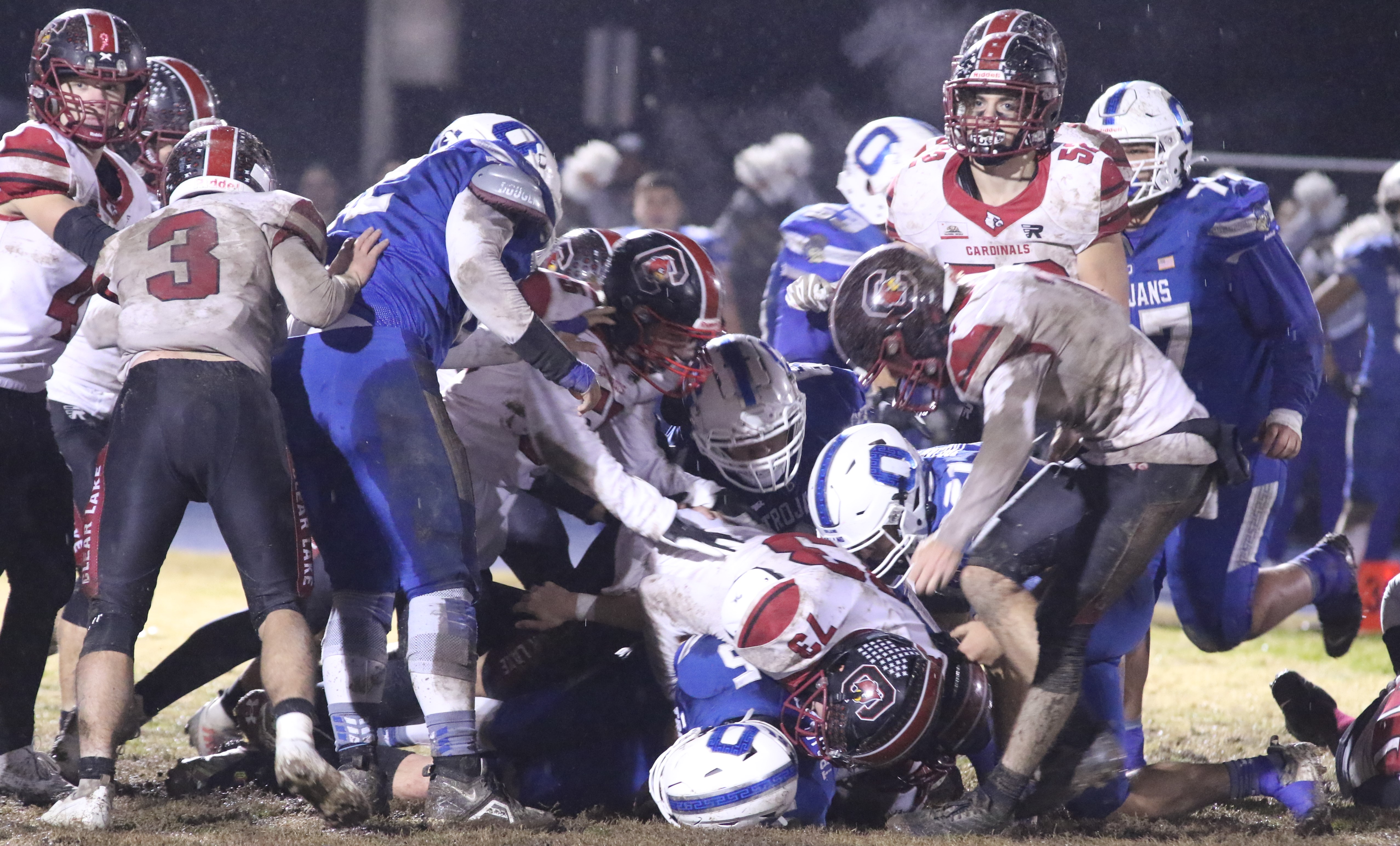 Orland's Alex Martinez didn't gain much on this carry against the Clear Lake defense Saturday night. The Cardinals stayed close to the Trojans most of the way before Orland broke things open in the final minutes for a 42-21 win in the 5-A NorCal championship game at Orland High School. (Photos by Minenna Photography)