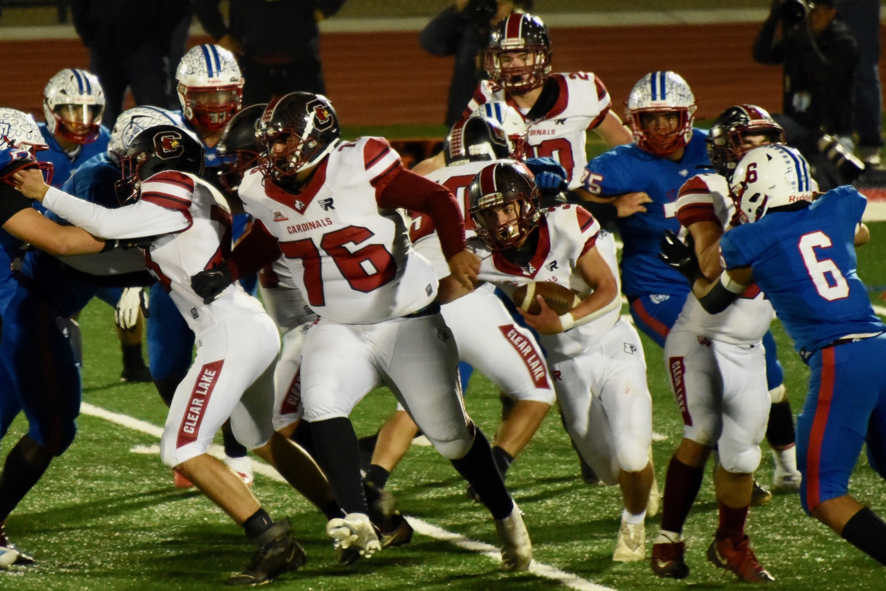 The Clear Lake offensive line, including Michael Freese (76), opens up a hole for running back Hank Ollenberger against St. Vincent. (Photos courtesy of Trett Bishop)