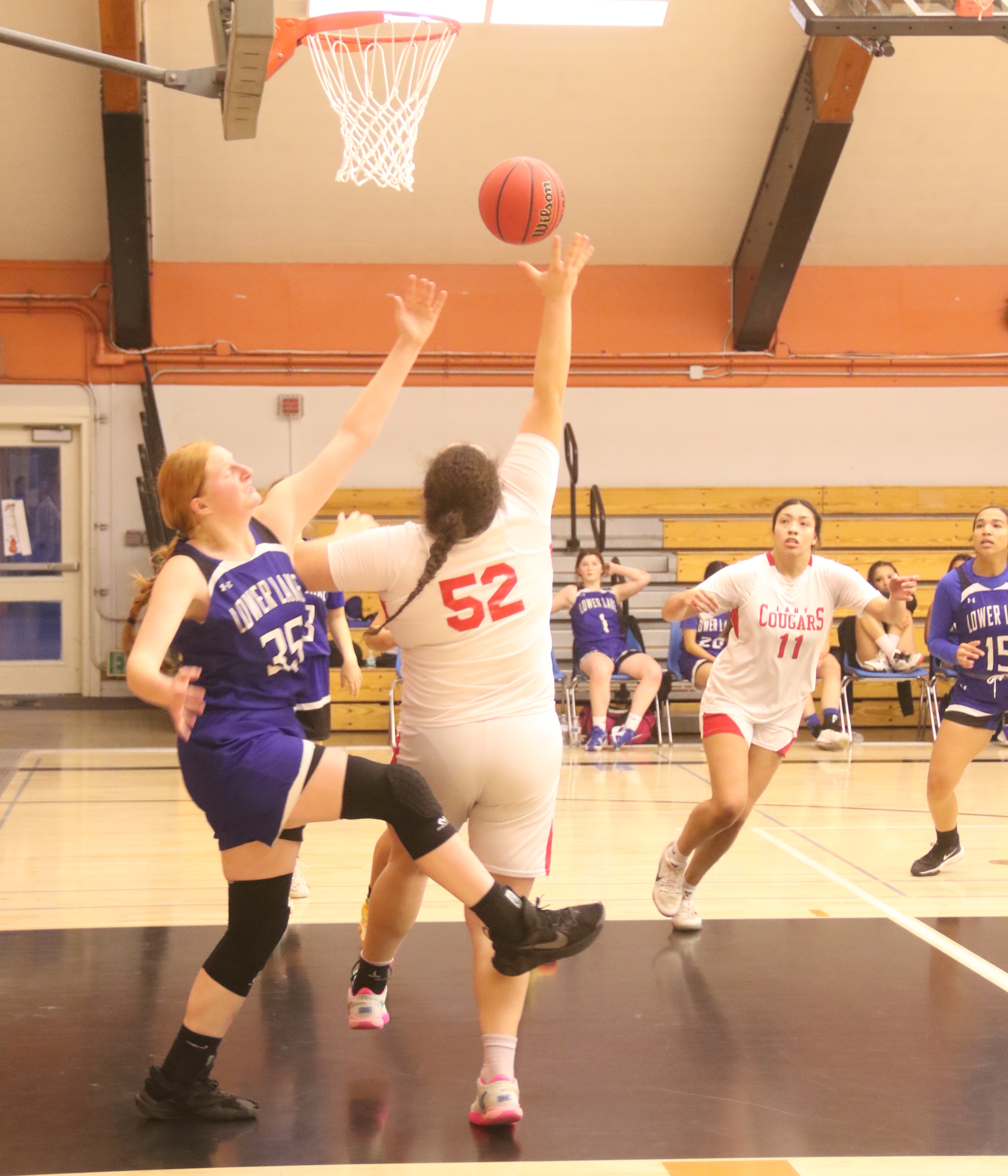 Upper Lake's Taylar Minnis (52) gets off a shot despite the best efforts of Lower Lake's Rebecca Theodorou. (Photos by Minenna Photography)