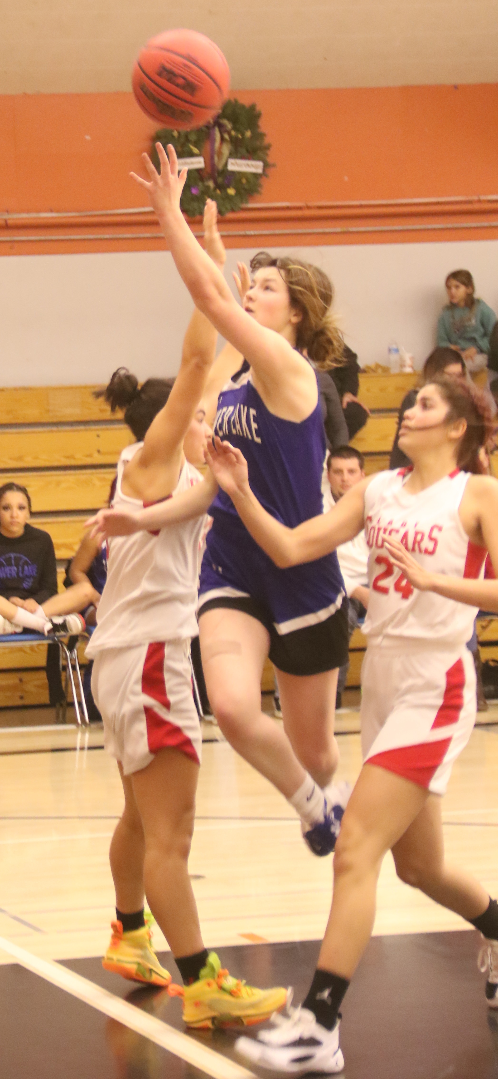 Lower Lake's Serenity McCoy cuts between Upper Lake defenders Maddy Young and Jordann Gudmundson on her way to the basket. (Photos by Minenna Photography)
