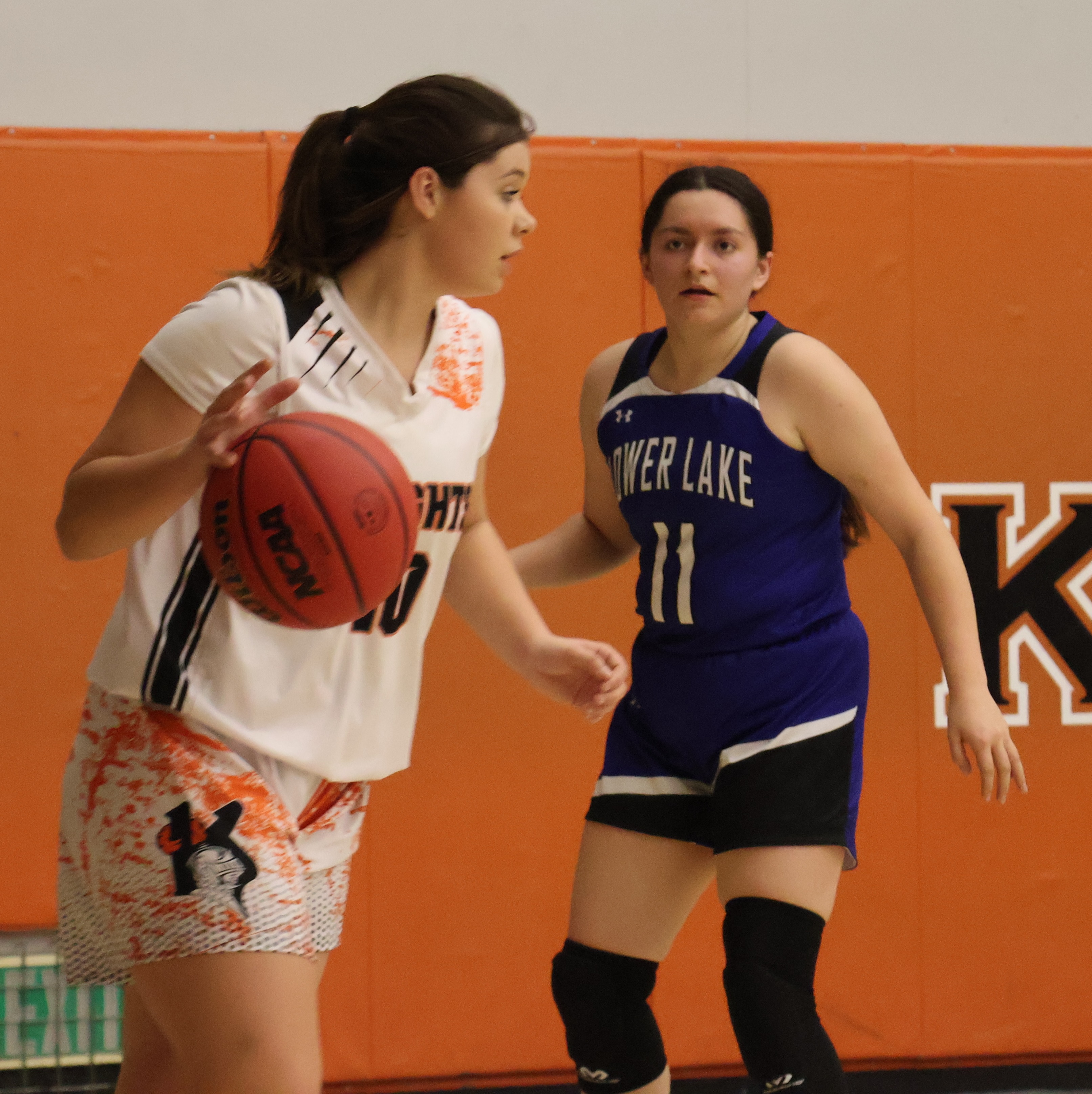 Kelseyville's Olivia Hommer looks for an open teammate as Lower Lake's Izabella Salazar looks on. Salazar scored what proved to be the winning basket in Lower Lake's 35-34 win Friday night at the Stokes Tournament in Kelseyville. (Photos by Brian Sumpter)