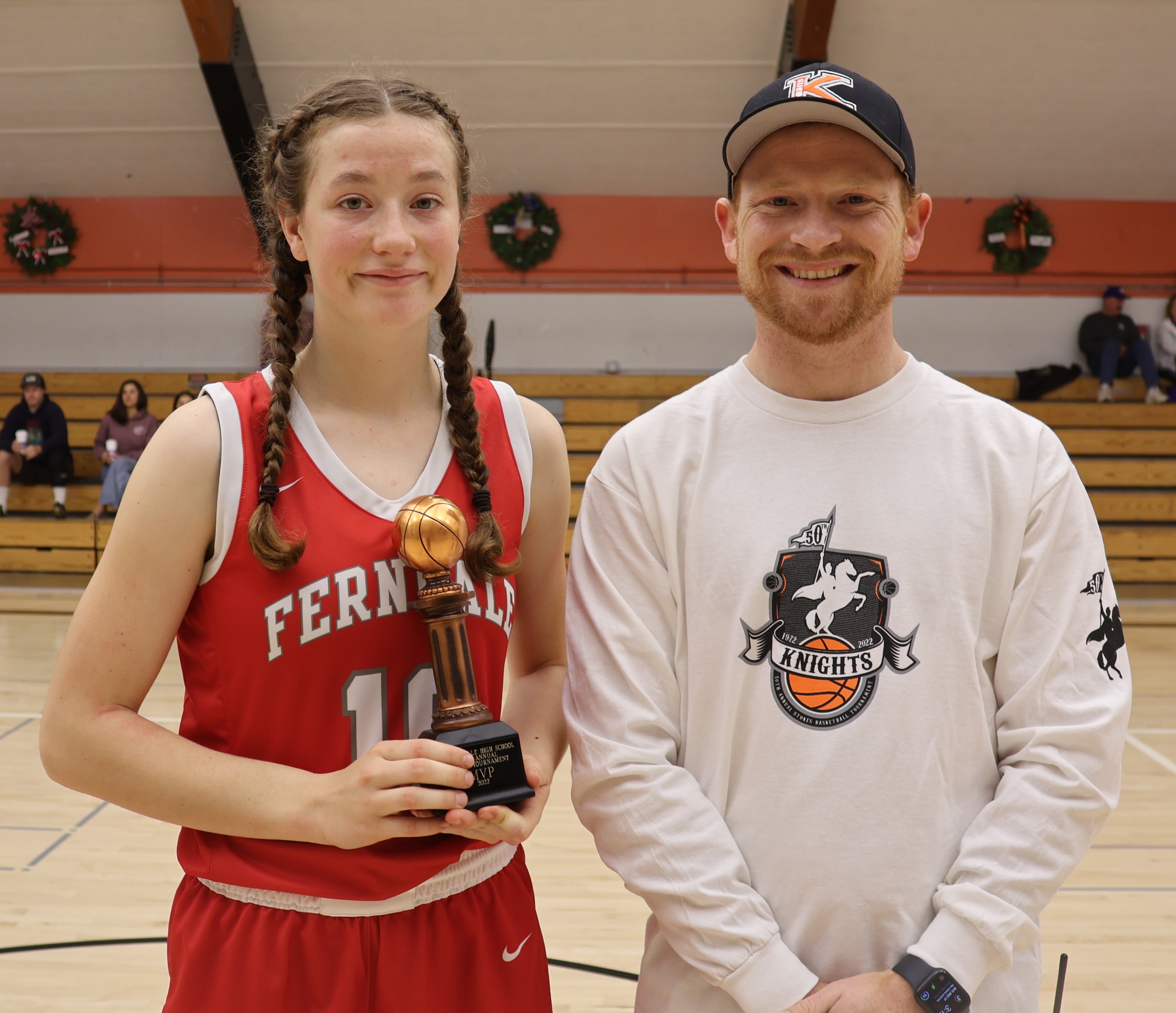 Ferndale's Kyla Albee received the Stokes Tournament most valuable player award from Kelseyville High School athletic director Shane Boehlert after leading the Wildcats to a title-clinching 46-10 win over Lower Lake on Saturday. (Photos by Brian Sumpter)