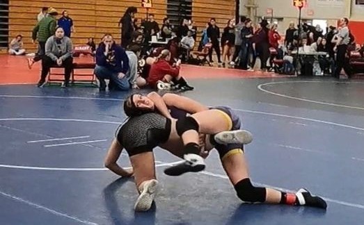 Middletown's Taylor Thompson (right) works over an opponent during Wednesday's action. Thompson won the 131-pound weight class. (Courtesy photos)
