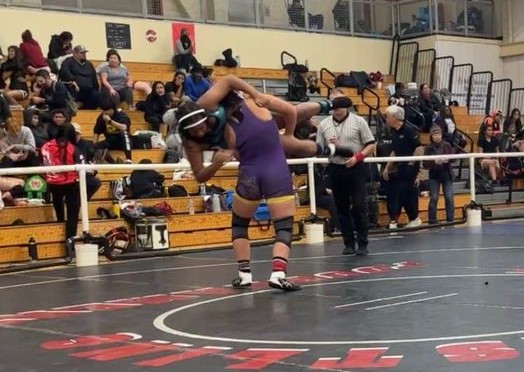Middletown's Krystal Ocken lifts an opponent off the mat during a 170-pound match. Ocken finished third. (Courtesy photos)