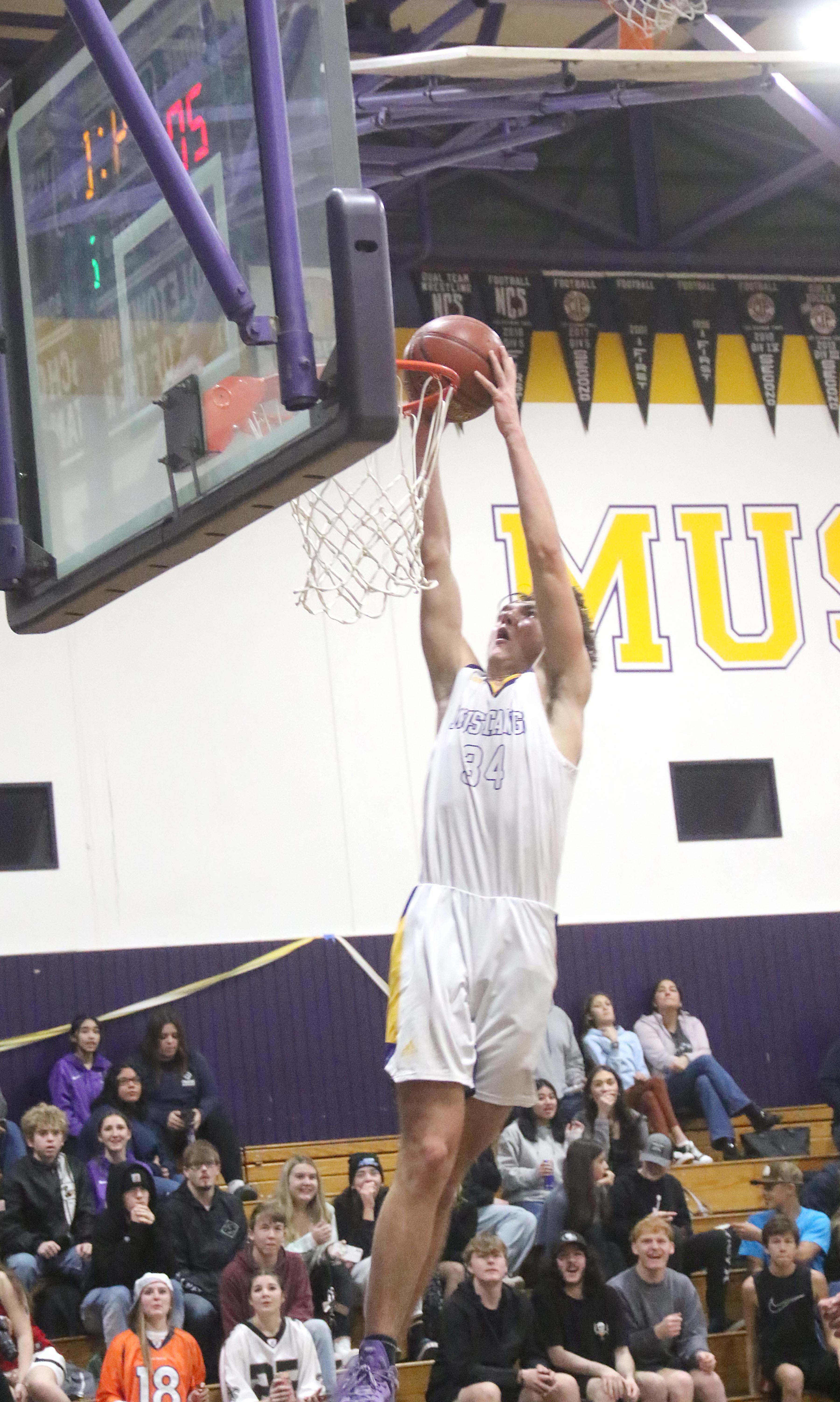 Middletown's Nadav Dicovski slams home two points in the second quarter against St. Helena. Dicovski had two dunks in the quarter and nine points overall. (Photos by Minenna Photography)