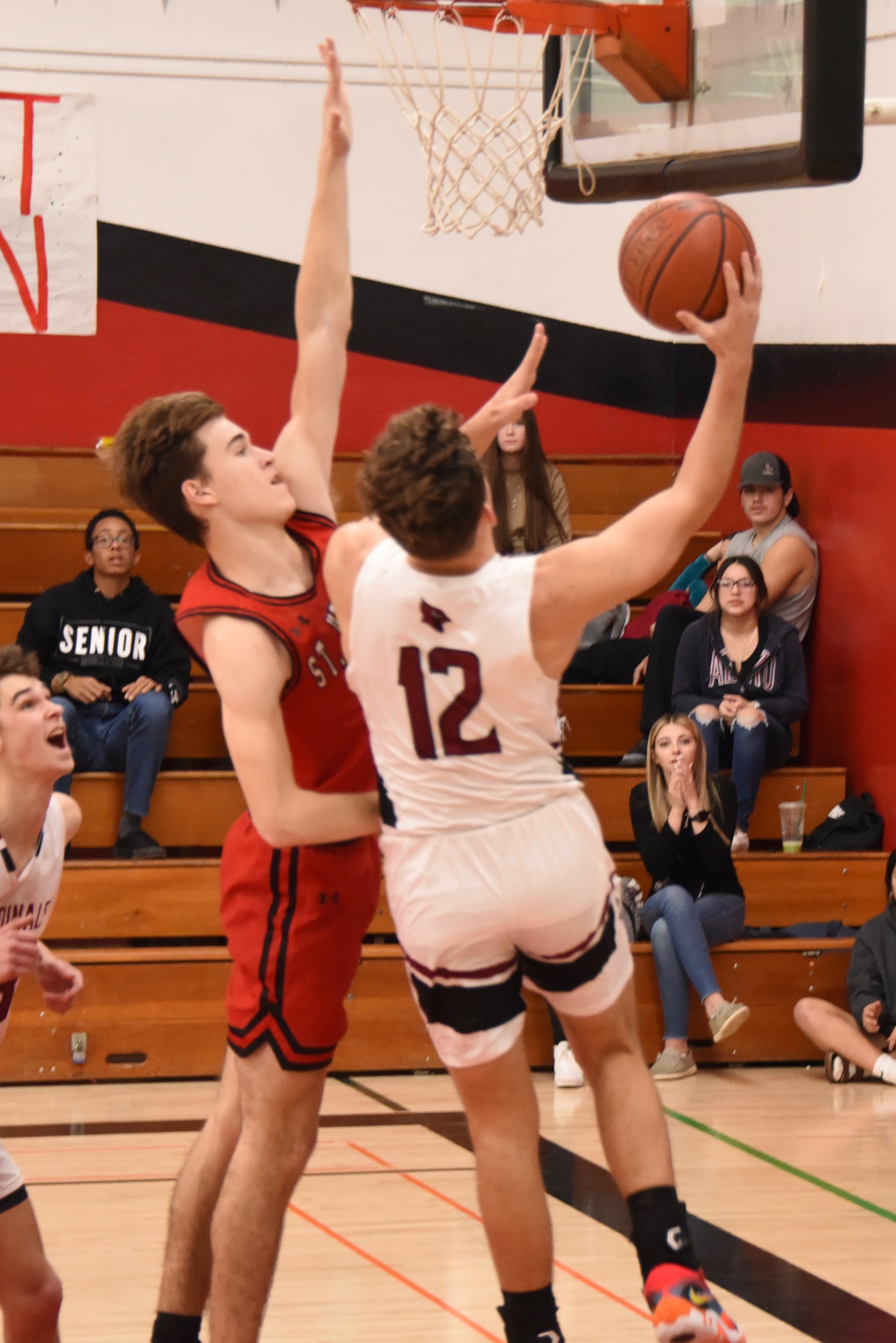 Clear Lake's Cody Hayes drives to the hoop against St. Helena. He scored 12 points in the Cardinals' 57-52 league loss.