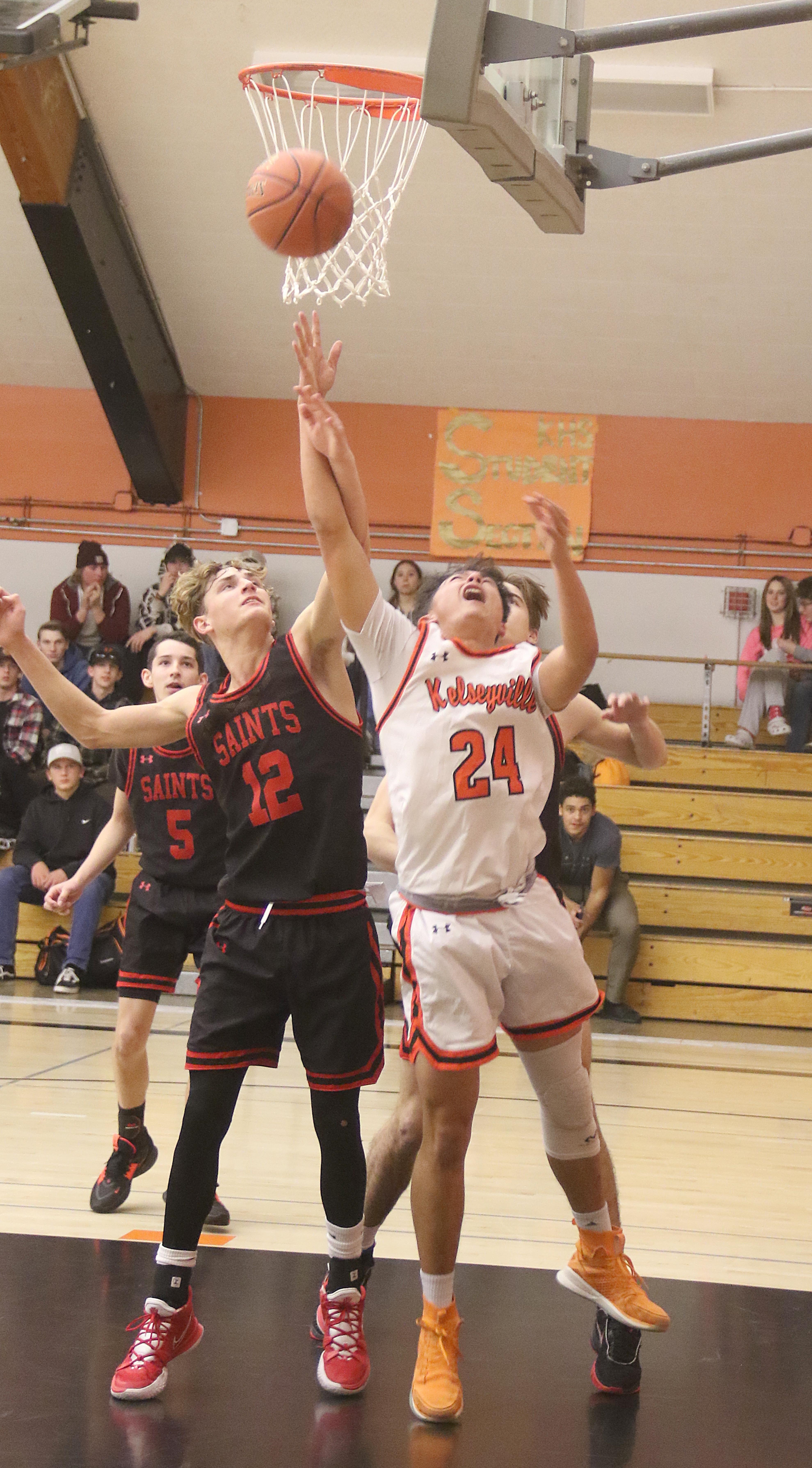 Upset that a foul wasn't called on this play early against St. Helena on Monday night, Kelseyville's Luke Watkins (24) ended up picking up two technical fouls -- one from each of two different officials -- and was ejected. The Knights still managed to beat the Saints 52-48. (Photos by Minenna Photography)