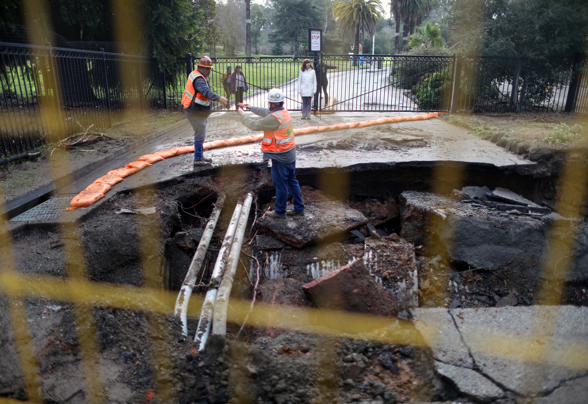 OAKLAND, CA JANUARY 3: Workers survey storm damage at the entrance of the Oakland Zoo on Tuesday, Jan. 3, 2023, in Oakland, Calif. (Aric Crabb/Bay Area News Group)