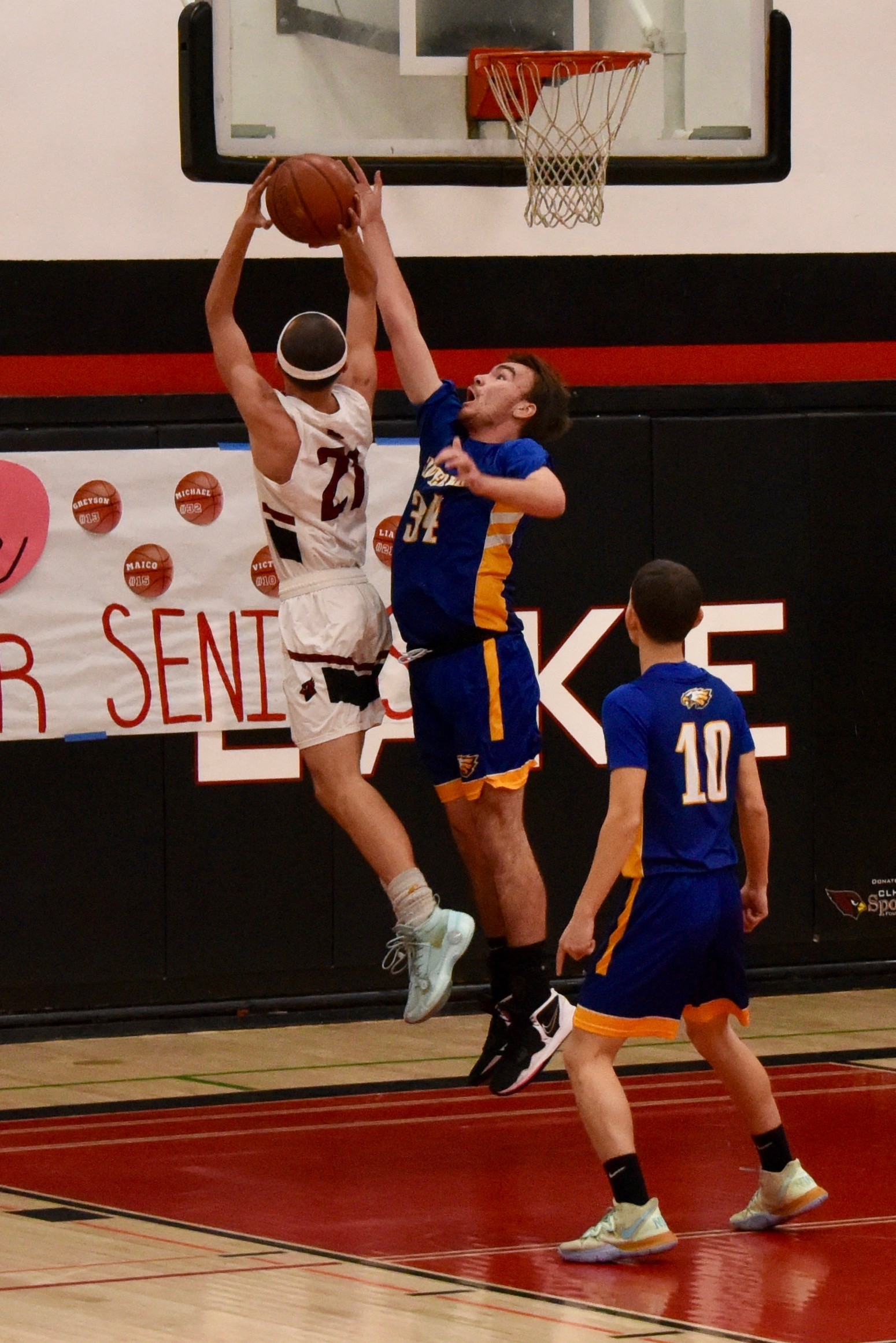 Cloverdale's Casey Lemley tries for the block as Clear Lake's Liam Orr powers his way inside Thursday night in Lakeport. Looking on is Cloverdale's Emilio Diaz. Cloverdale beat Clear Lake 61-38 to improve to 15-0 in league play. (Photos courtesy of Trett Bishop)