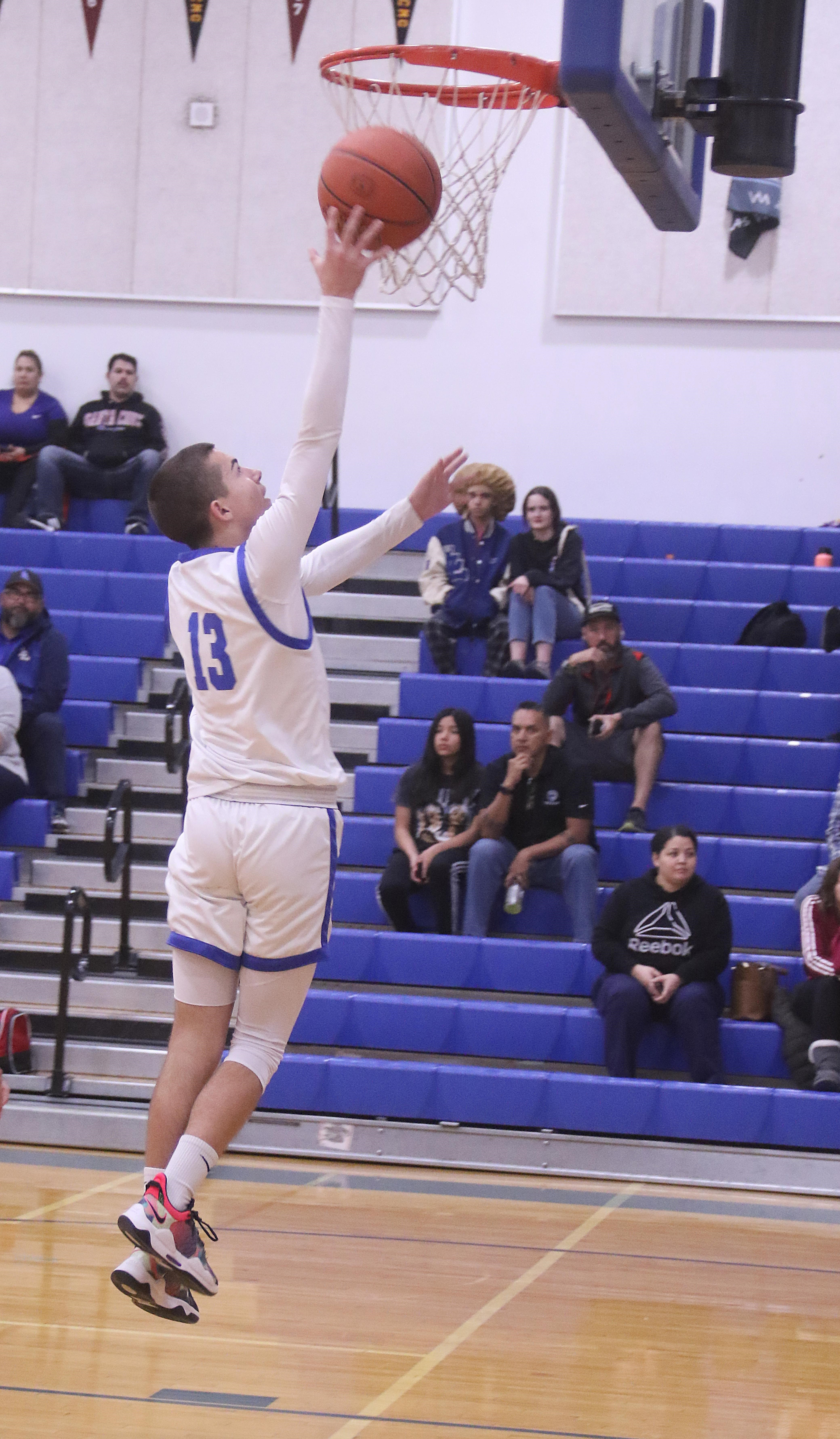 Jett Guralas lays in two of his team-leading 21 points for Lower Lake against St. Helena. (Photos by Minenna Photography)