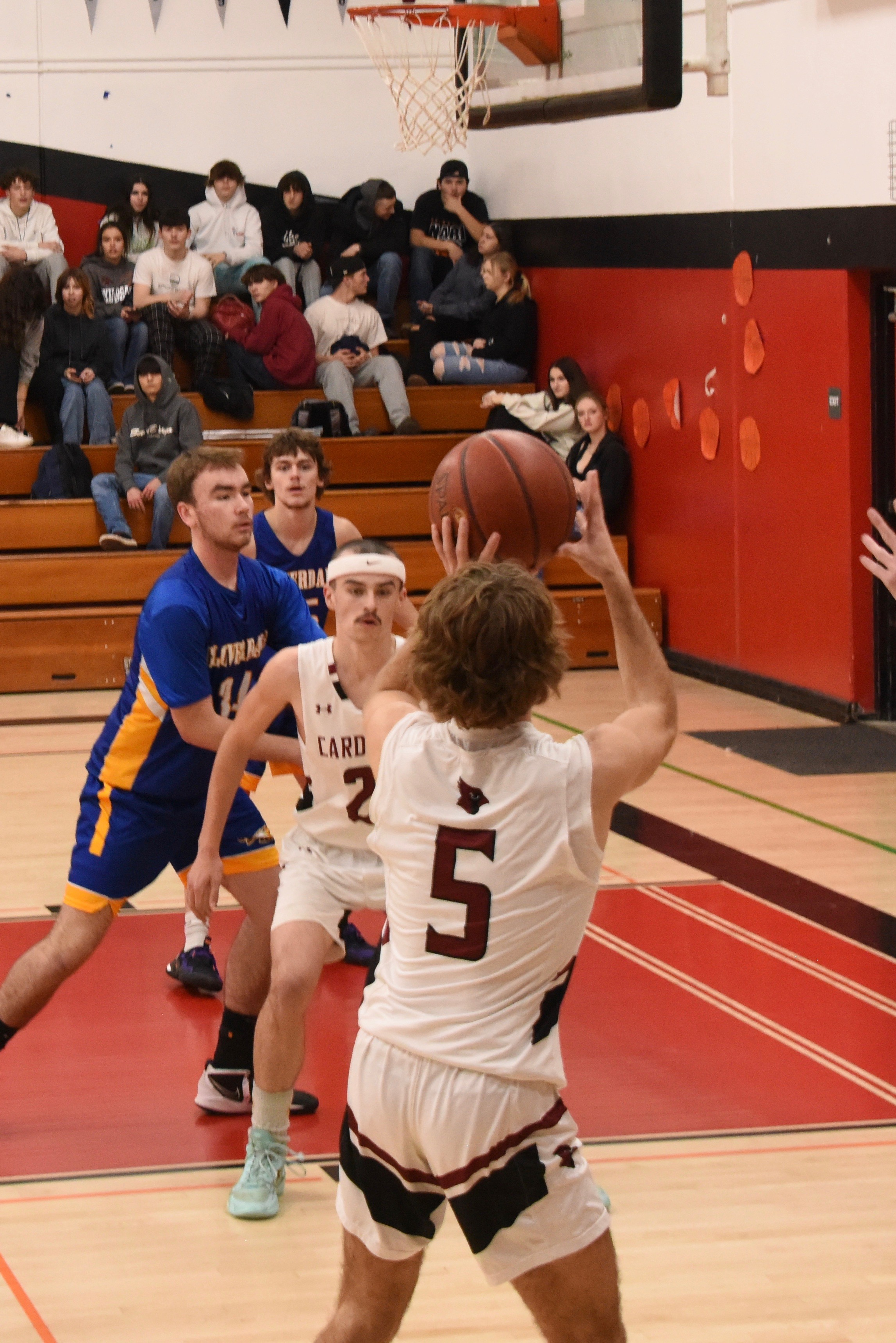 Clear Lake's Jake Soderquist launches a 3-pointer as teammate Liam Orr and Cloverdale's Casey Lemley battle for position underneath the basket. (Photos courtesy of Trett Bishop)