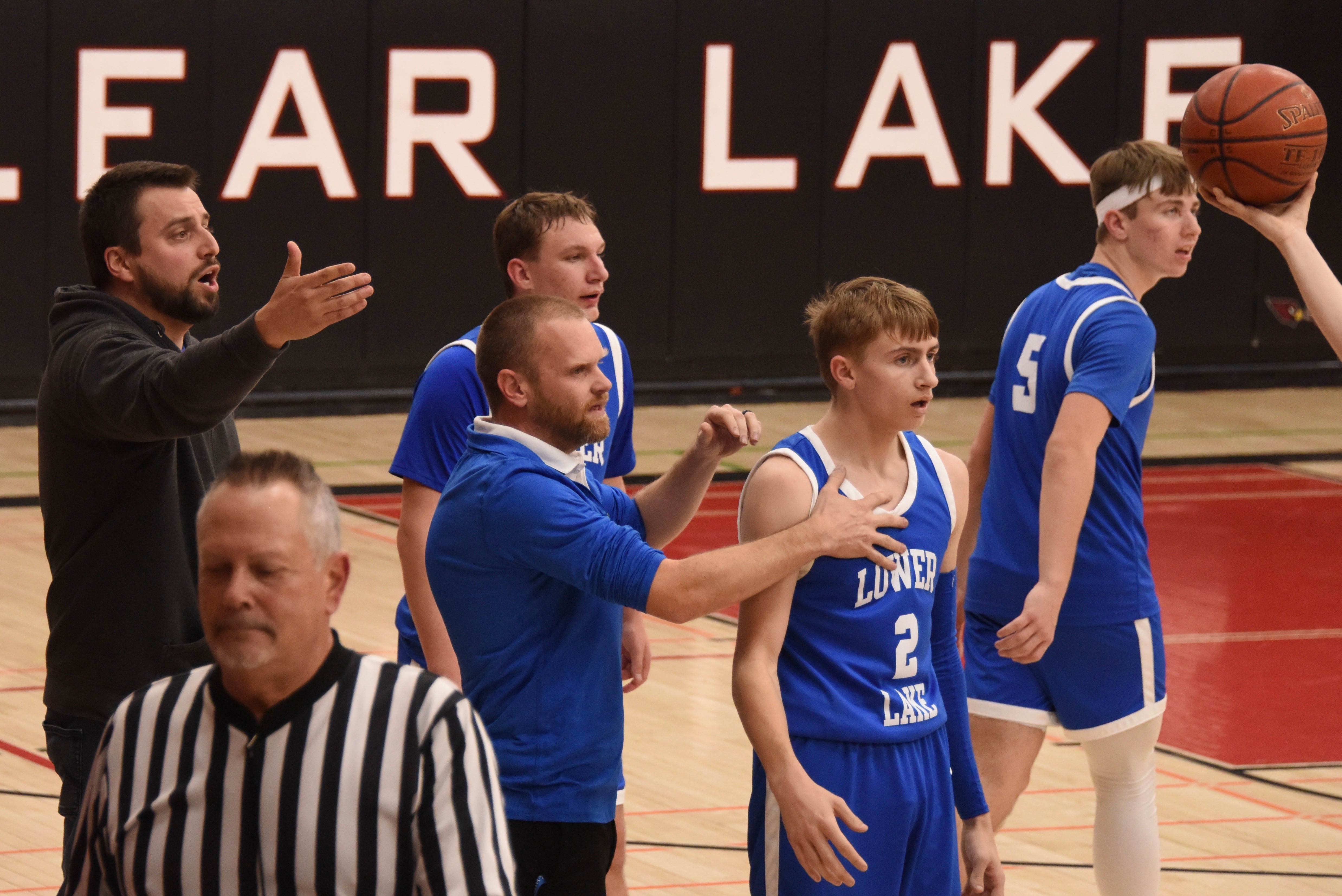 Lower Lake head coach Bryce Brin (center) and other members of the Lower Lake team, including Dylan Sherman (2), react to the final play of the game. (Photos courtesy of Trett Bishop)