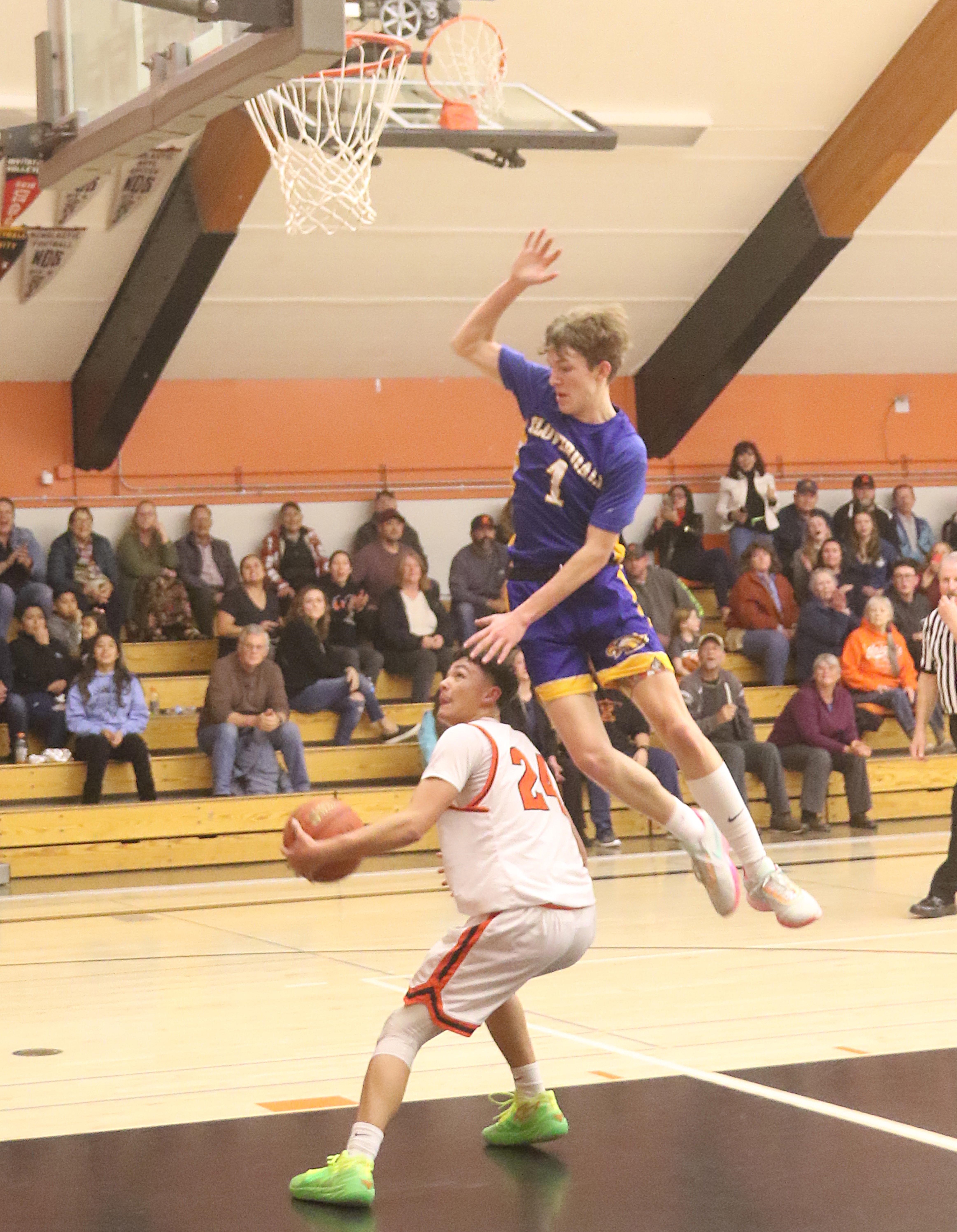 Kelseyville's Luke Watkins ducks under Cloverdale Tatum Kurpinsky during action Tuesday night in Kelseyville. Kurpinsky's 30 points powered the Eagles to a 71-67 overtime victory. (Photos by Minenna Photography)