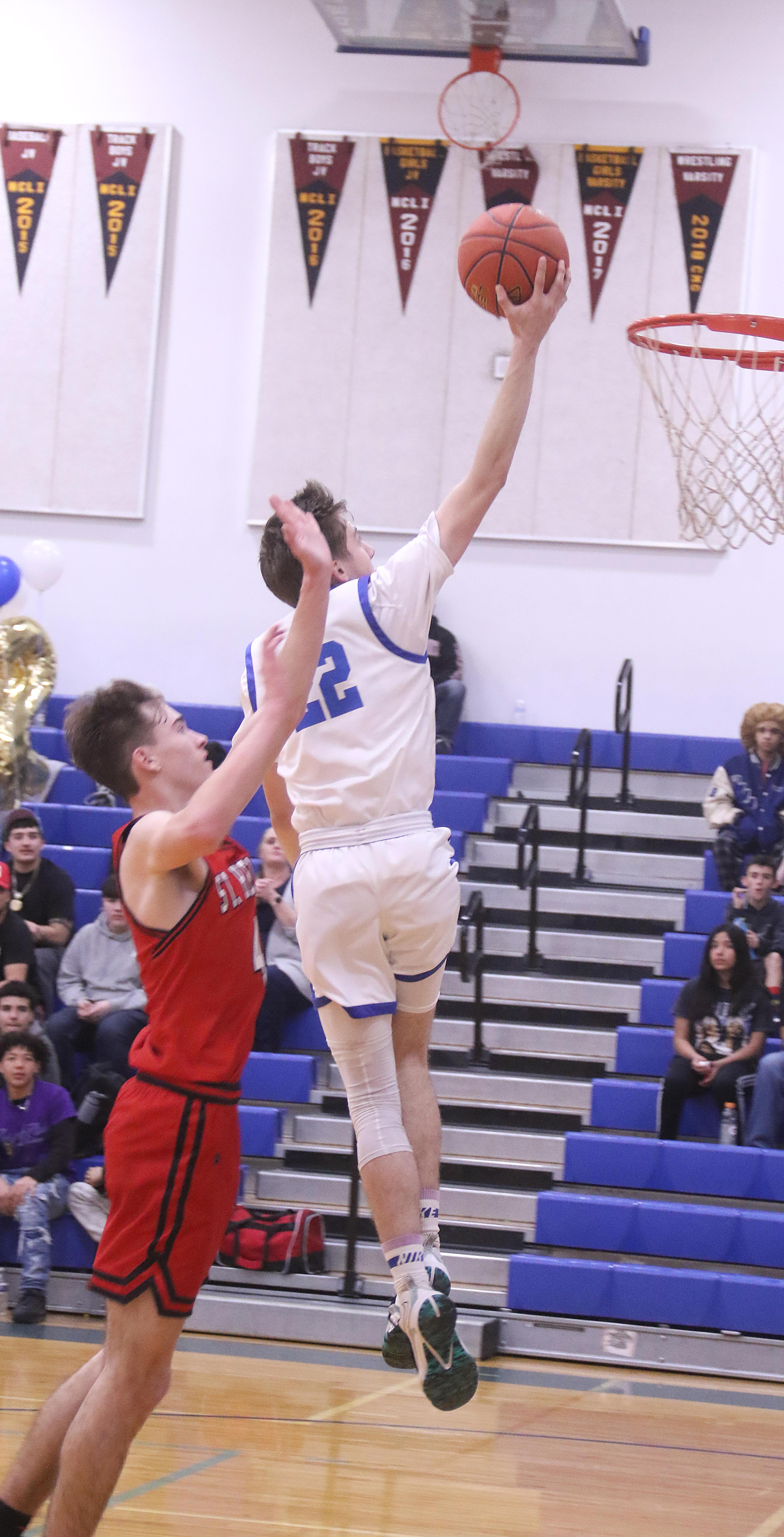 Jett Guralas catches some air on his way to the basket against St. Helena. (Photos by Minenna Photography)