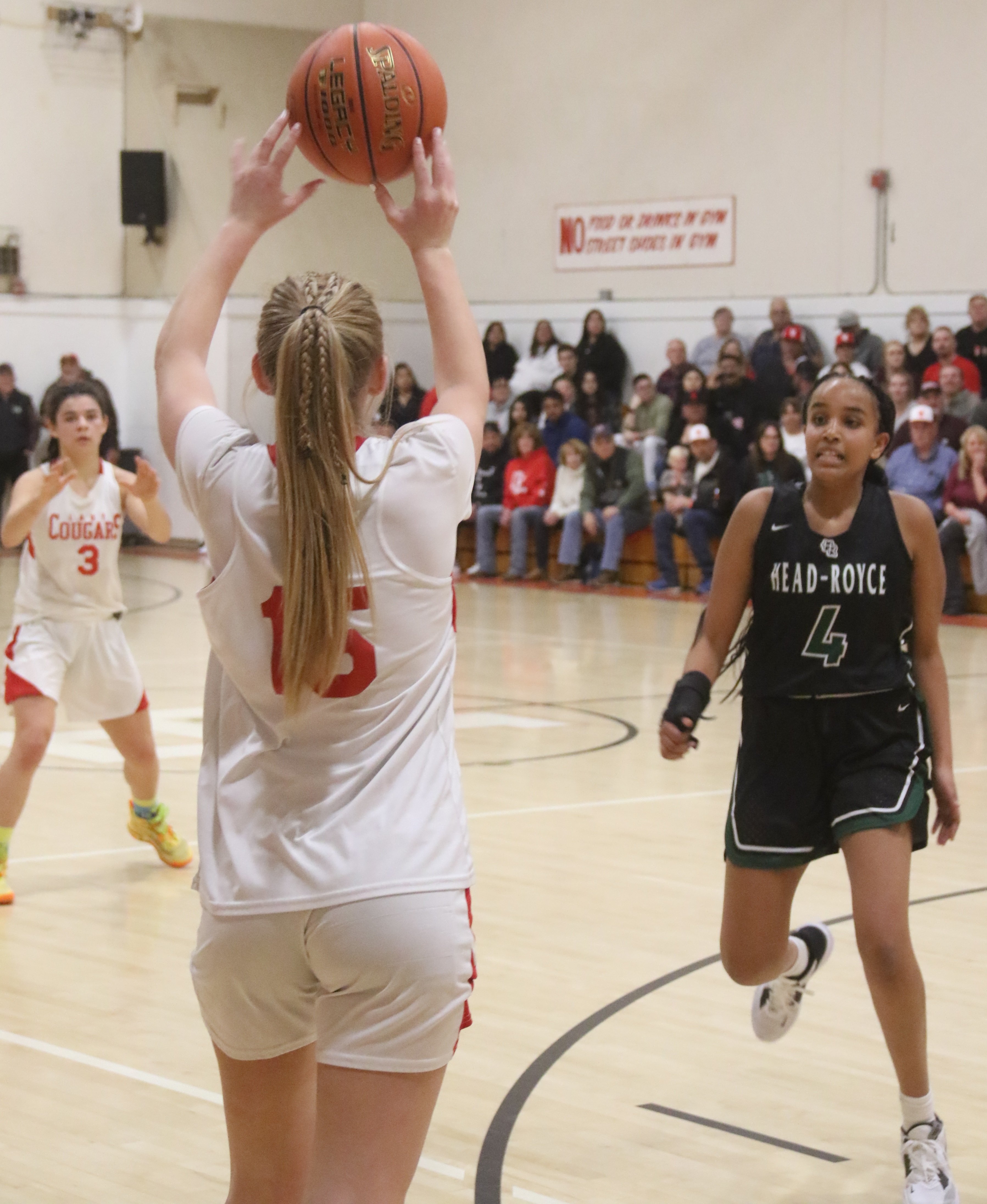 Upper Lake's Madison Noble passes the ball to teammate Maddy Young in the second half as Head-Royce's Leila Haile defends. Noble scored nine points and had a big night on the boards against the Jayhawks. (Photos by Minenna Photography)