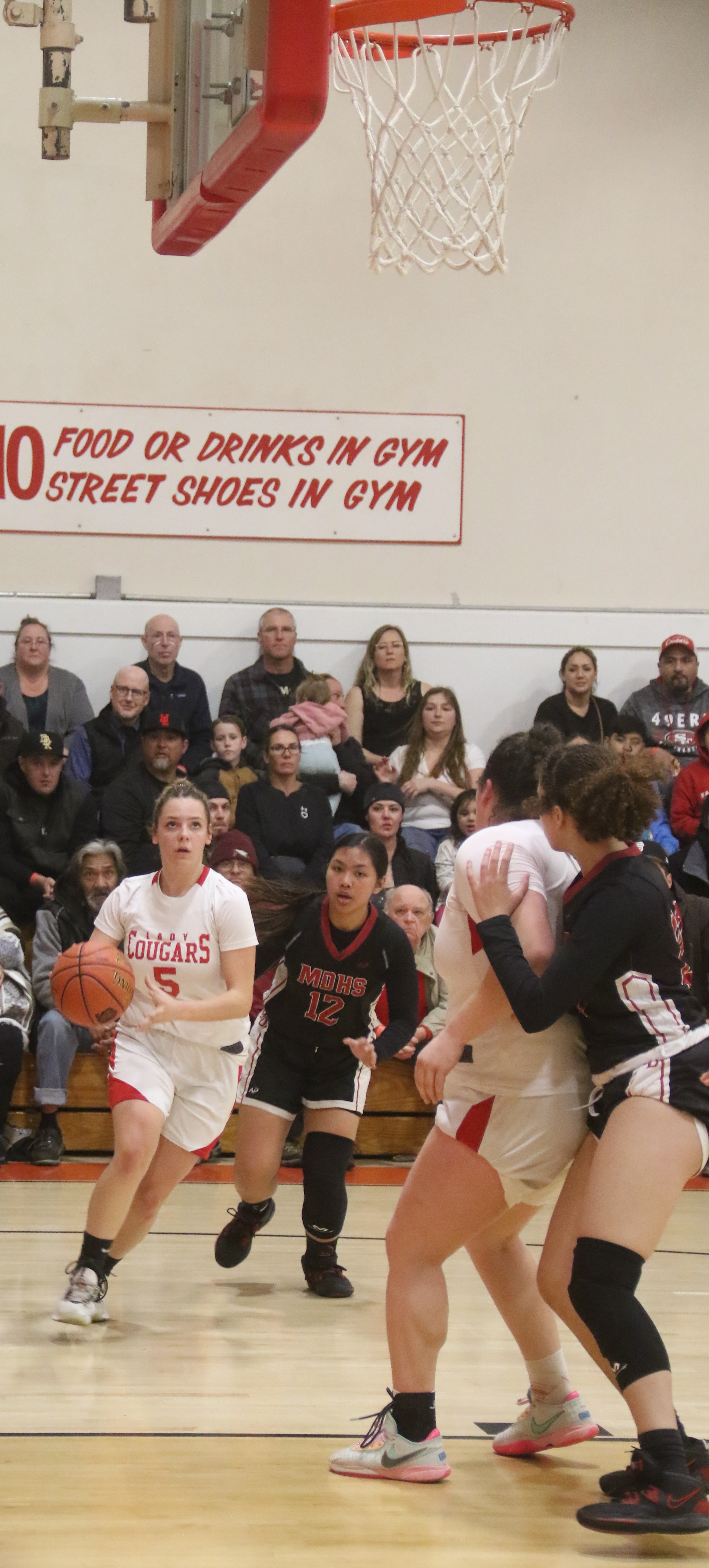 Upper Lake's Jayme Zimmerschied makes a break for the basket as teammate Taylar Minnis screens out a Mount Diablo player. Zimmerschied scored 17 points in the Cougars' 65-52 playoff win, including five 3-pointers. (Photos by Minenna Photography)
