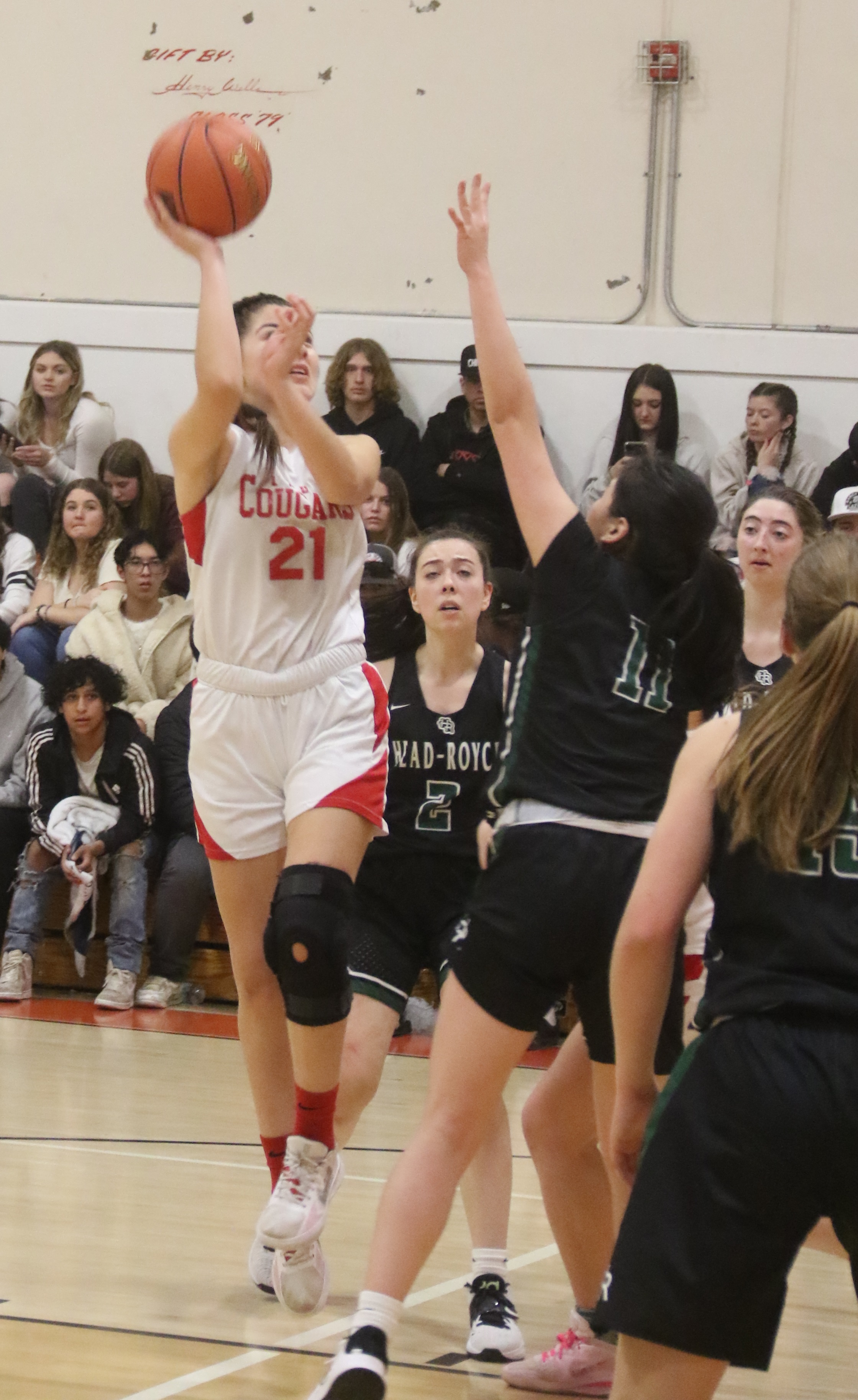 Upper Lake's Kat Lopez-Geary puts up a one-handed shot while drawing a host of Head-Royce defenders, including Alice Zhu (11) and Elena Krauss (11). Lopez-Geary hit a 3-pointer and had a three-point play among her eight points in a 56-38 win over the Jayhawks. (Photos by Minenna Photography)