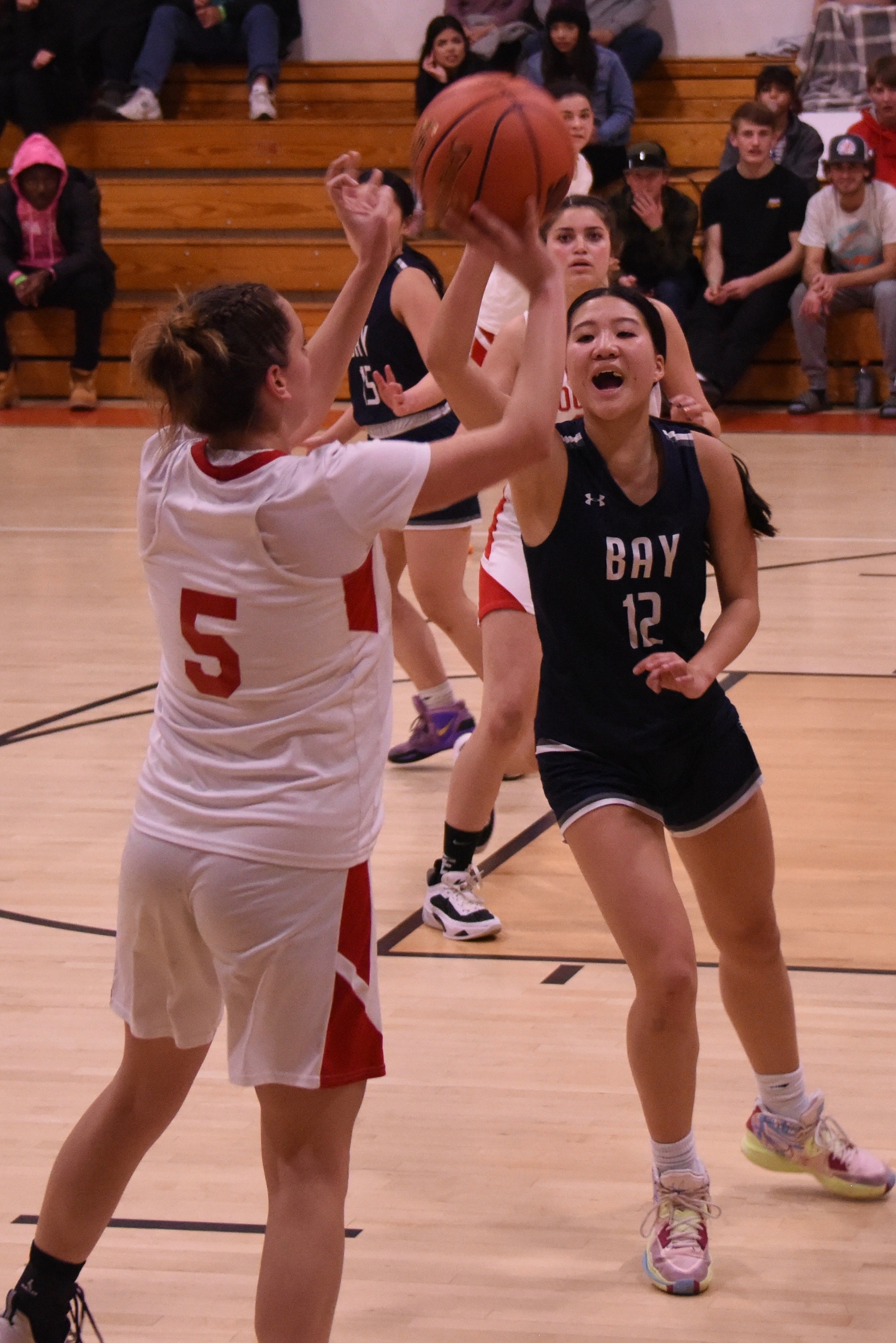 Upper Lake's Jayme Zimmerschied released a 3-point shot in the second half as The Bay School's Riley Topacio defends. Zimmerschield sank four 3-pointers and finished with 16 points in the Cougars' 47-29 playoff win. (Photos courtesy of Trett Bishop)