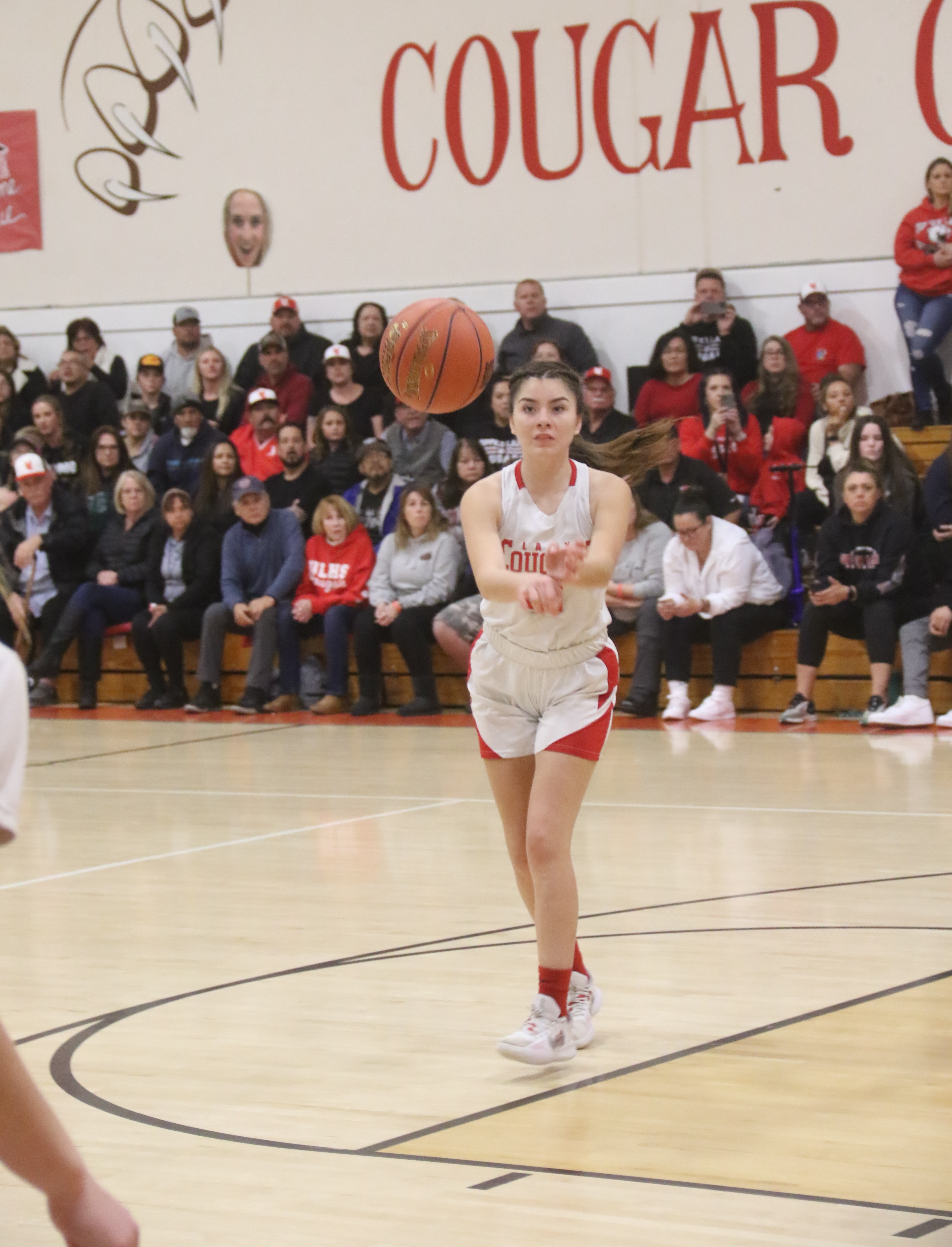 Upper Lake's Kat Lopez-Geary fires a pass to open teammate Jayme Zimmerschied, who is positioned behind the 3-point line.(Photos by Minenna Photography)