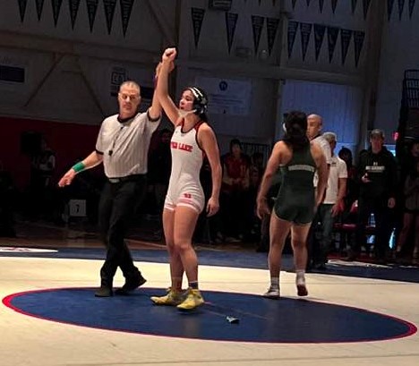 The official raises Maddy Young's arm after her 4-3 win in the 131-pound finals Saturday evening in Albany. (Courtesy photos)