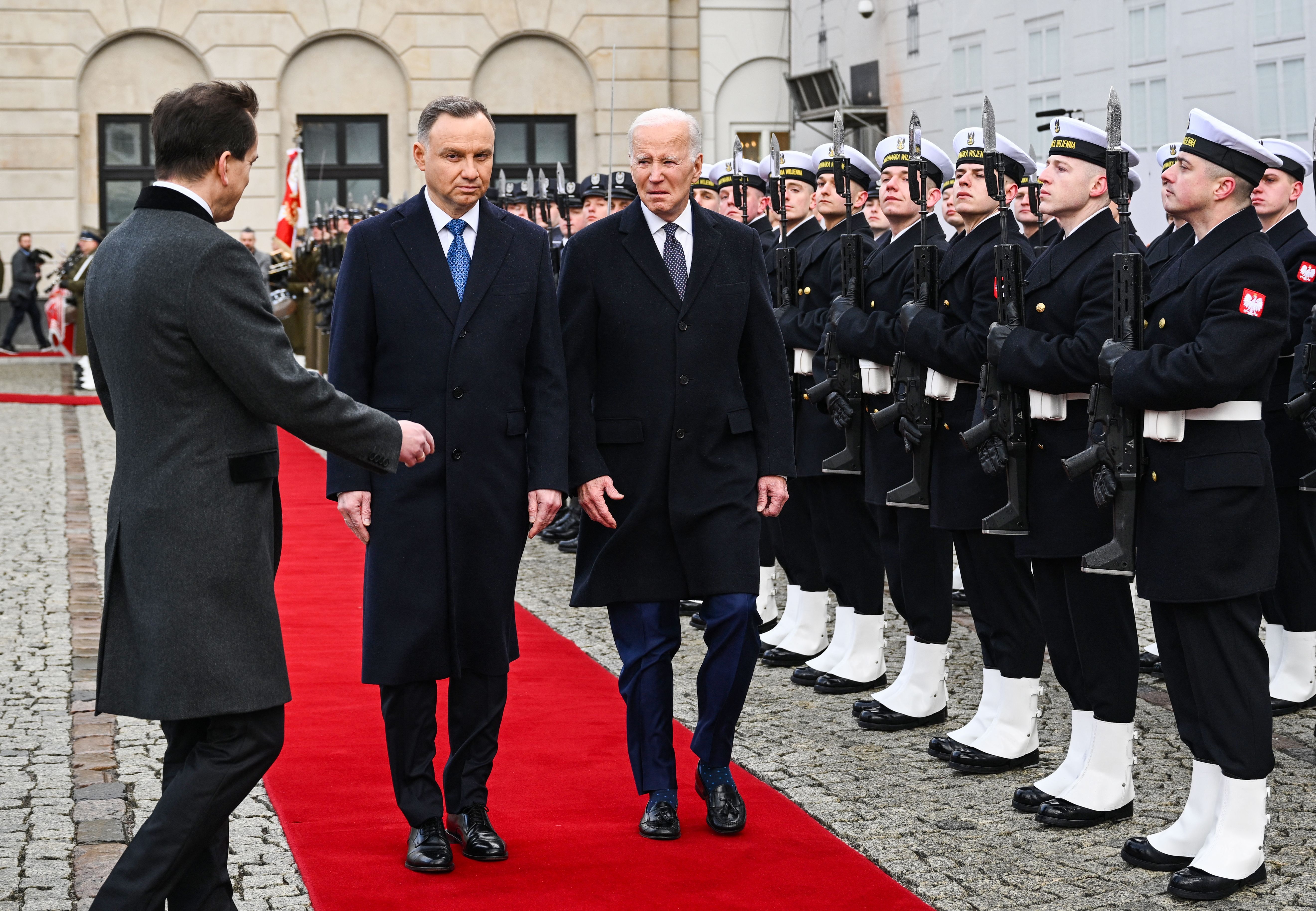 U.S. President Joe Biden, right, and Polish President Andrzej Duda review a military honour guard during a welcoming ceremony prior to talks at the Presidential Palace in Warsaw on Feb. 21, 2023.
