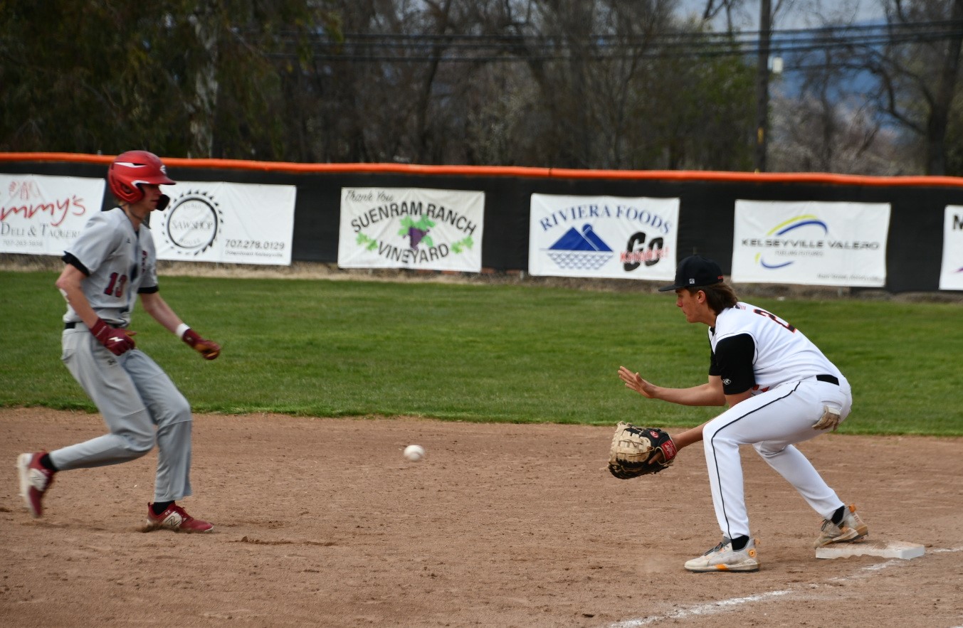 Kelseyville first baseman Tyler Bryant waits for the throw while doubling off Clear Lake's Greyson Wind on a flyout to left field. Outfielder Reme Strong made the throw to first base. (Photos courtesy of Marcy Leboy)