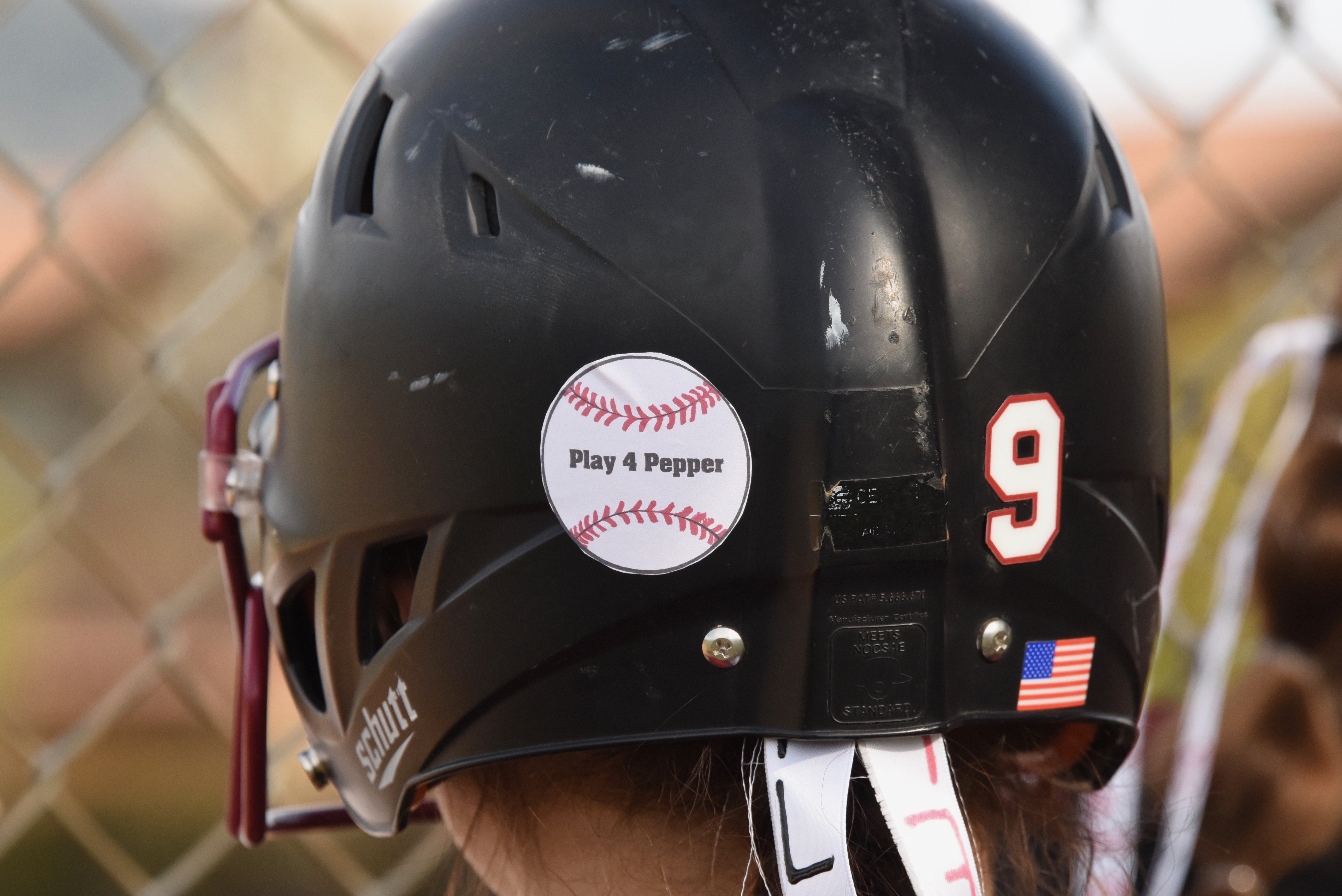 Jazmine Ledesma looks on from the dugout during Clear Lake's 8-7 softball win over Ukiah on Friday at the Cloverdale Tournament. The Cardinals are wearing "Play For Pepper" hair ribbons and "Play 4 Pepper" stickers on their batting helmets to honor Clear Lake High School varsity baseball coach Ed Pepper, who died Thursday. (Photos by Trett Bishop)