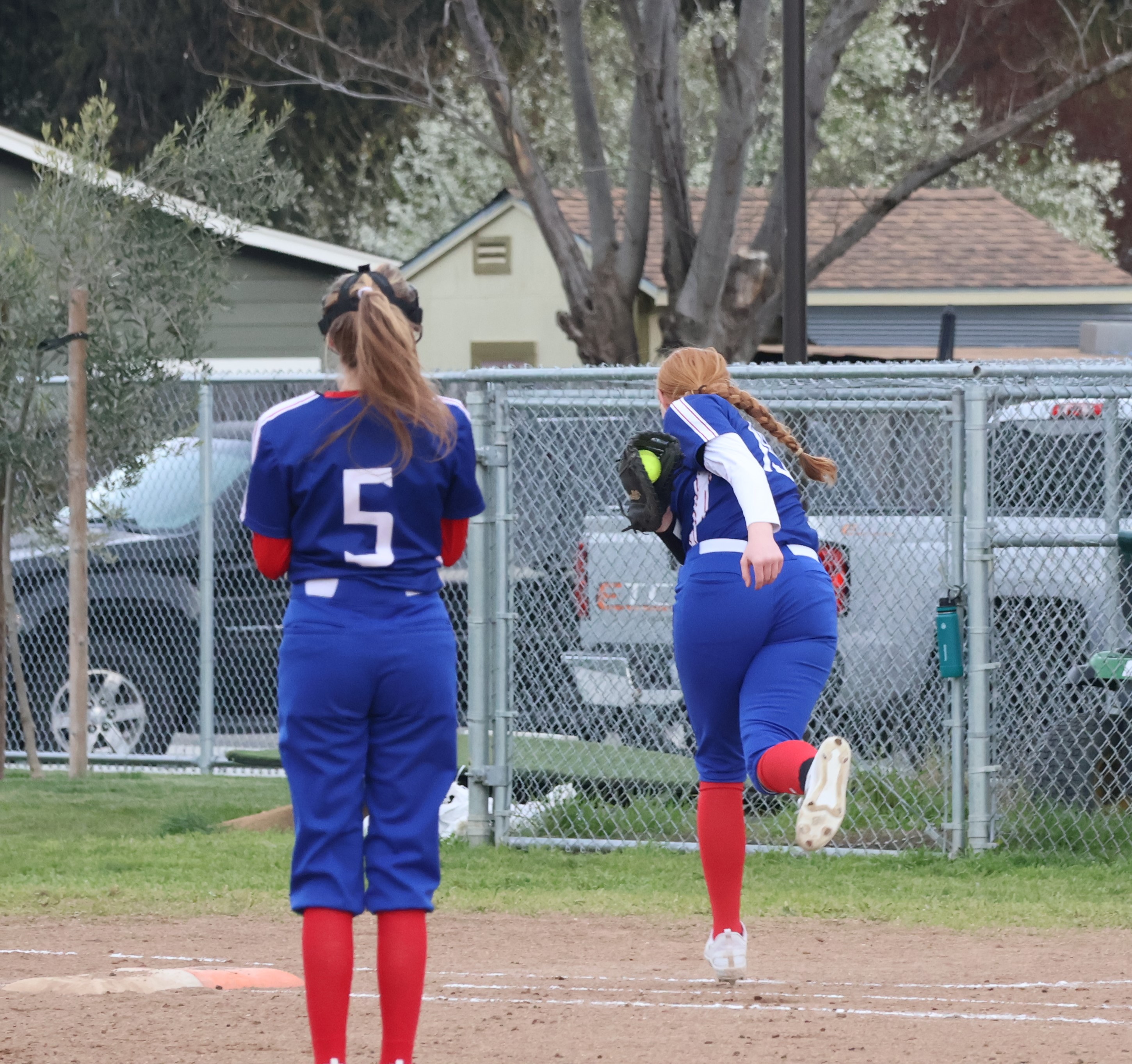 Lower Lake first baseman Rebecca Thedorou makes the catch in foul territory as pitcher Keeley Parks looks on. (Photos by Brian Sumpter)