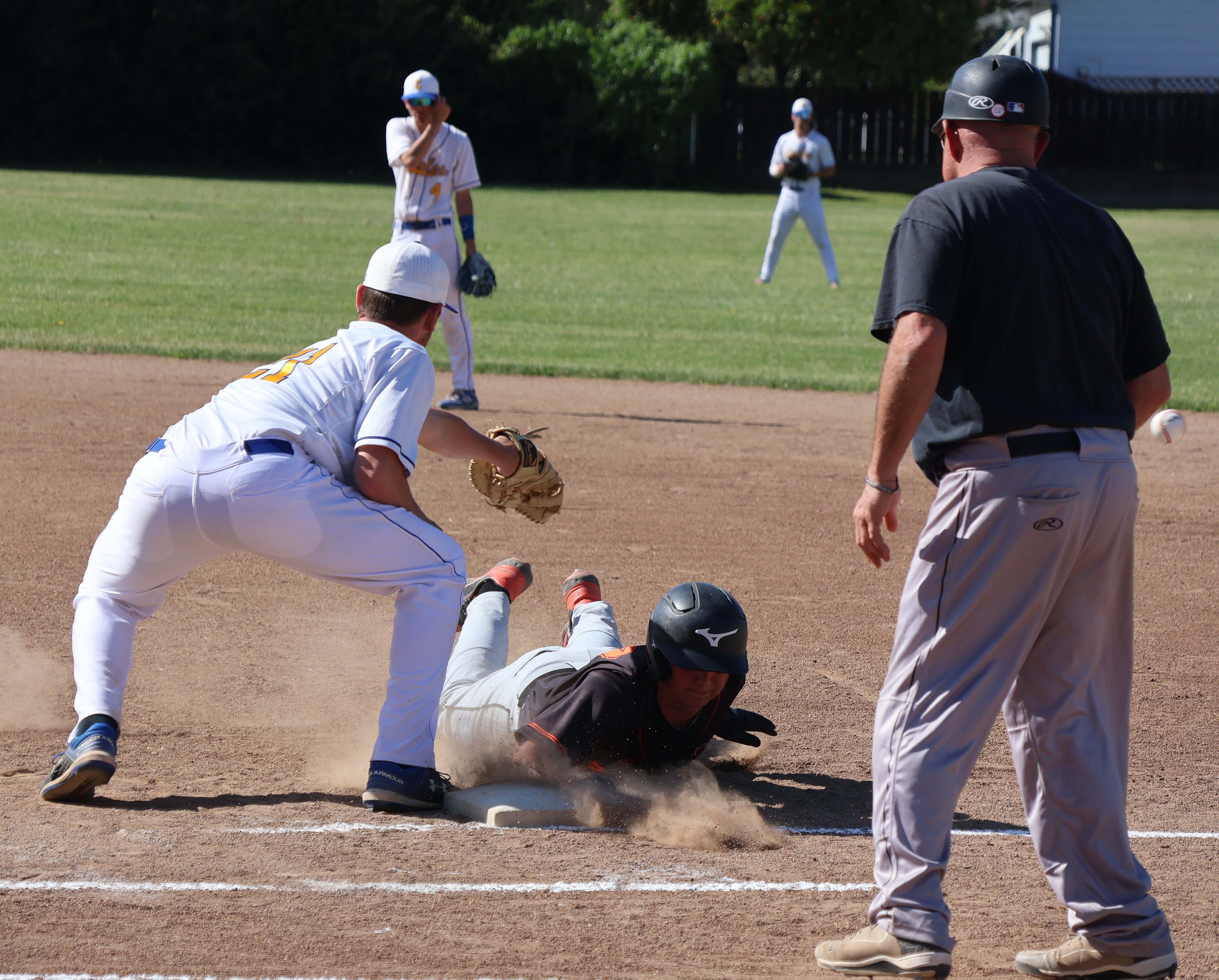 Kelseyville's Zayne Barker slides safely back into the bag on a pickoff throw at first base. The throw skipped past the first baseman for an error, allowing Barker to advance to second base. The senior went 3-for-3 with a RBI in the Knights' 6-2 win at Cloverdale. (Photos by Brian Sumpter)