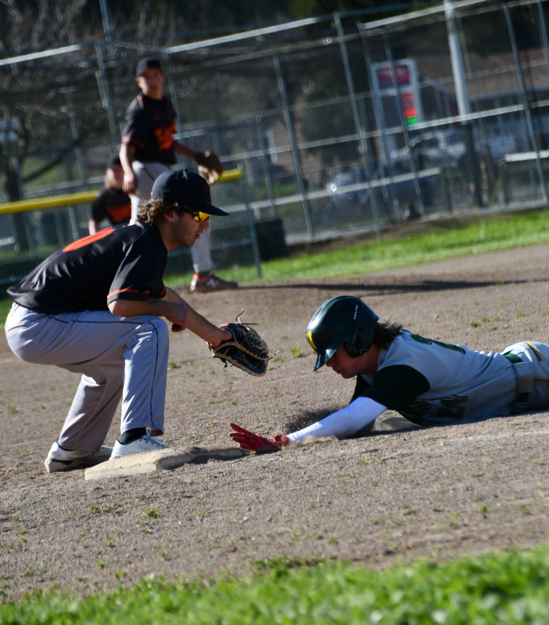 Kelseyville first baseman Andrew Huggins prepares to slap a tag on a Willits runner sliding back into first base during a pickoff play. Following the action is pitcher Brock Barrick. (Photos courtesy of Marcy Leboy)