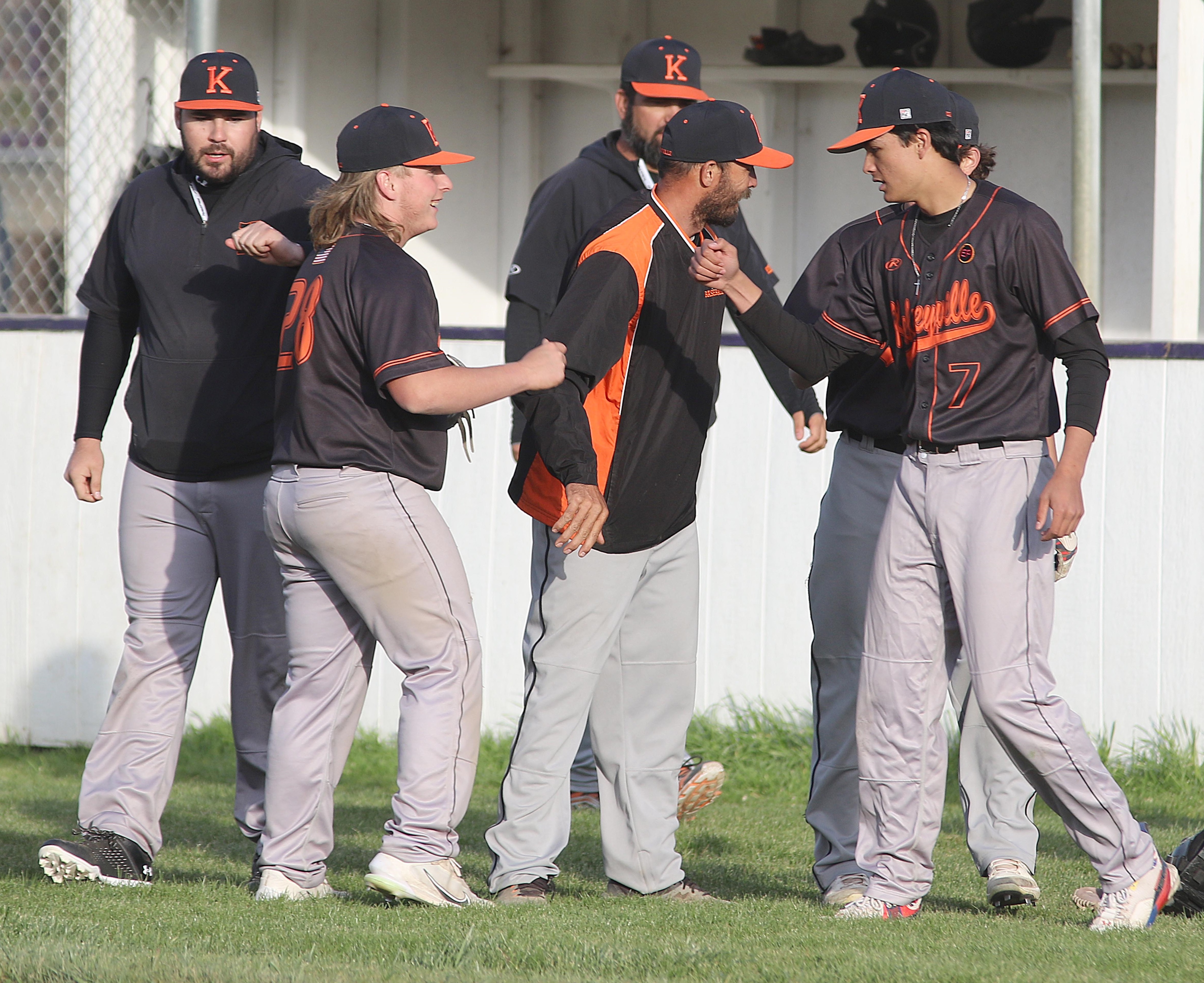 Kelseyville players and coaches, including Jon Dougherty (28) and Luke Watkins (7), celebrate after Dougherty pitched a 1-2-3 bottom of the seventh to seal a 9-8 victory over Middletown. (Photos by Minenna Photography)