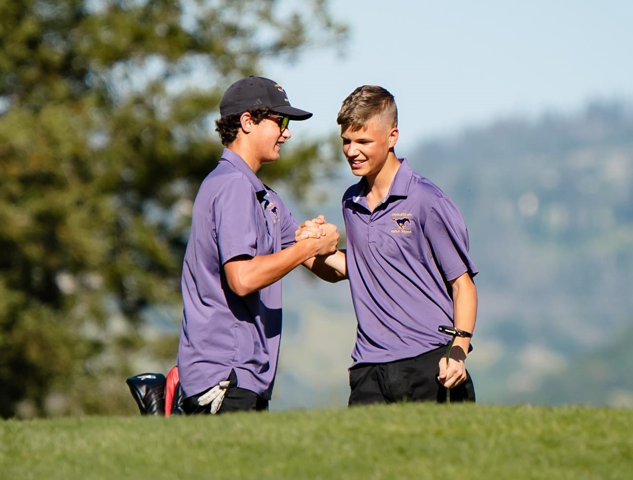 Middletown's Bodhi Moore (left) congratulates teammate Dom Williams after his 35-foot putt for eagle on the 17th hole Thursday afternoon at Windsor Golf Club. (Photos courtesy of Geri Costlow)