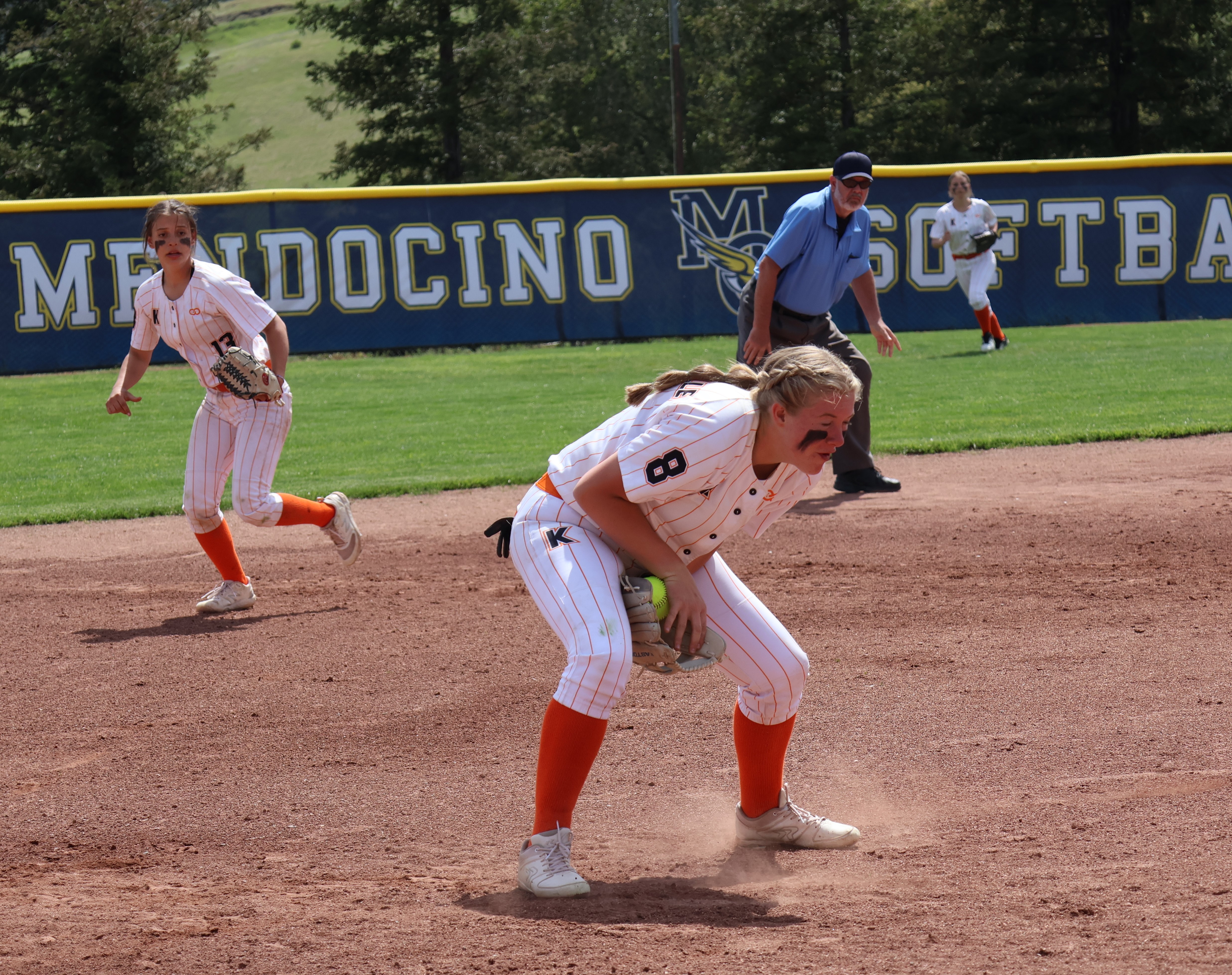 Kelseyville third baseman Faith McIntire gloves a hard grounder before throwing out the Hoopa runner at first base. Circling behind her is shortstop Cali Schnabl. (Photos by Brian Sumpter)