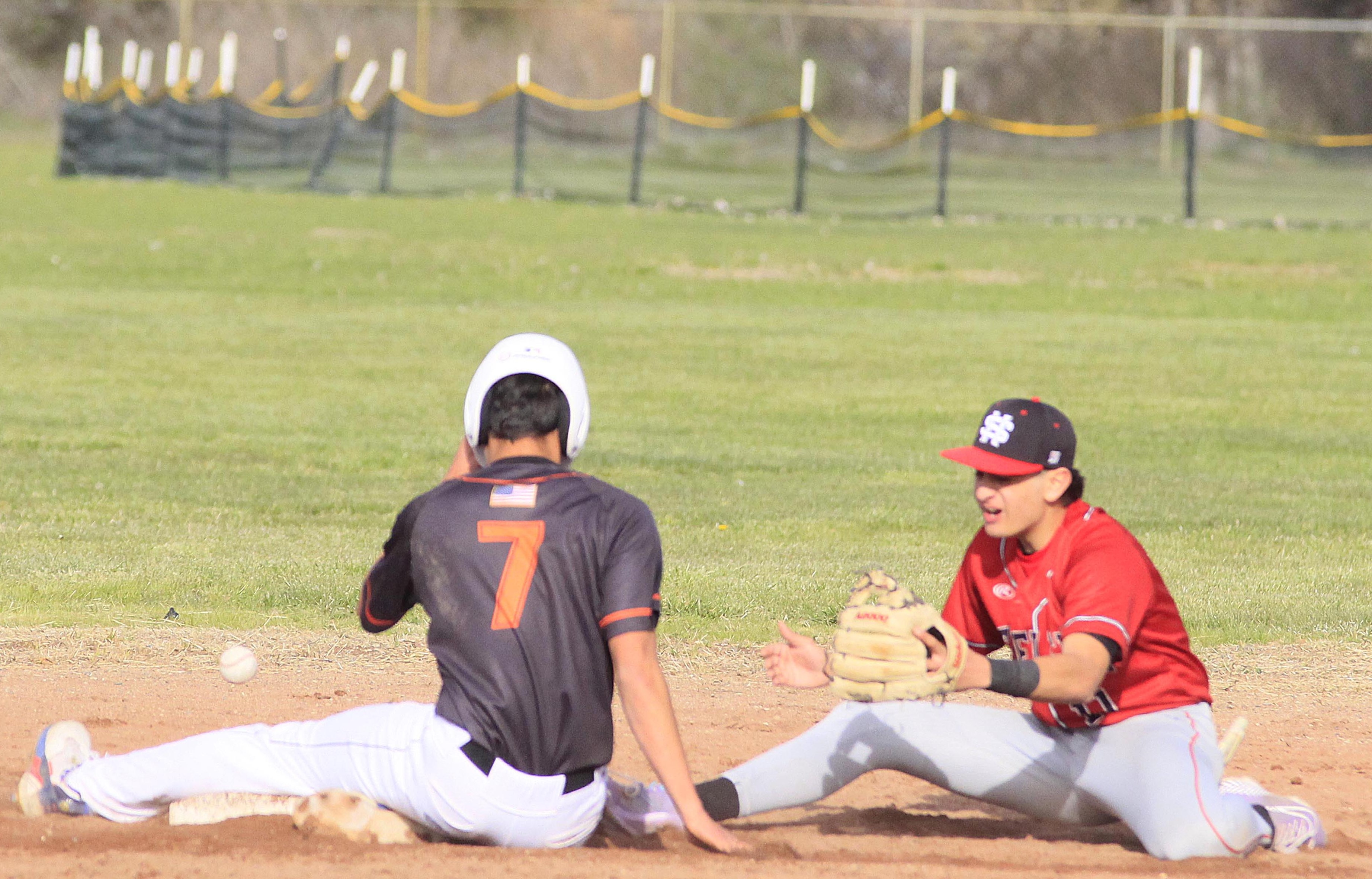 Kelseyville's Luke Watkins (7) adjusts his helmet after sliding into second base. (Photo by Minenna Photography)