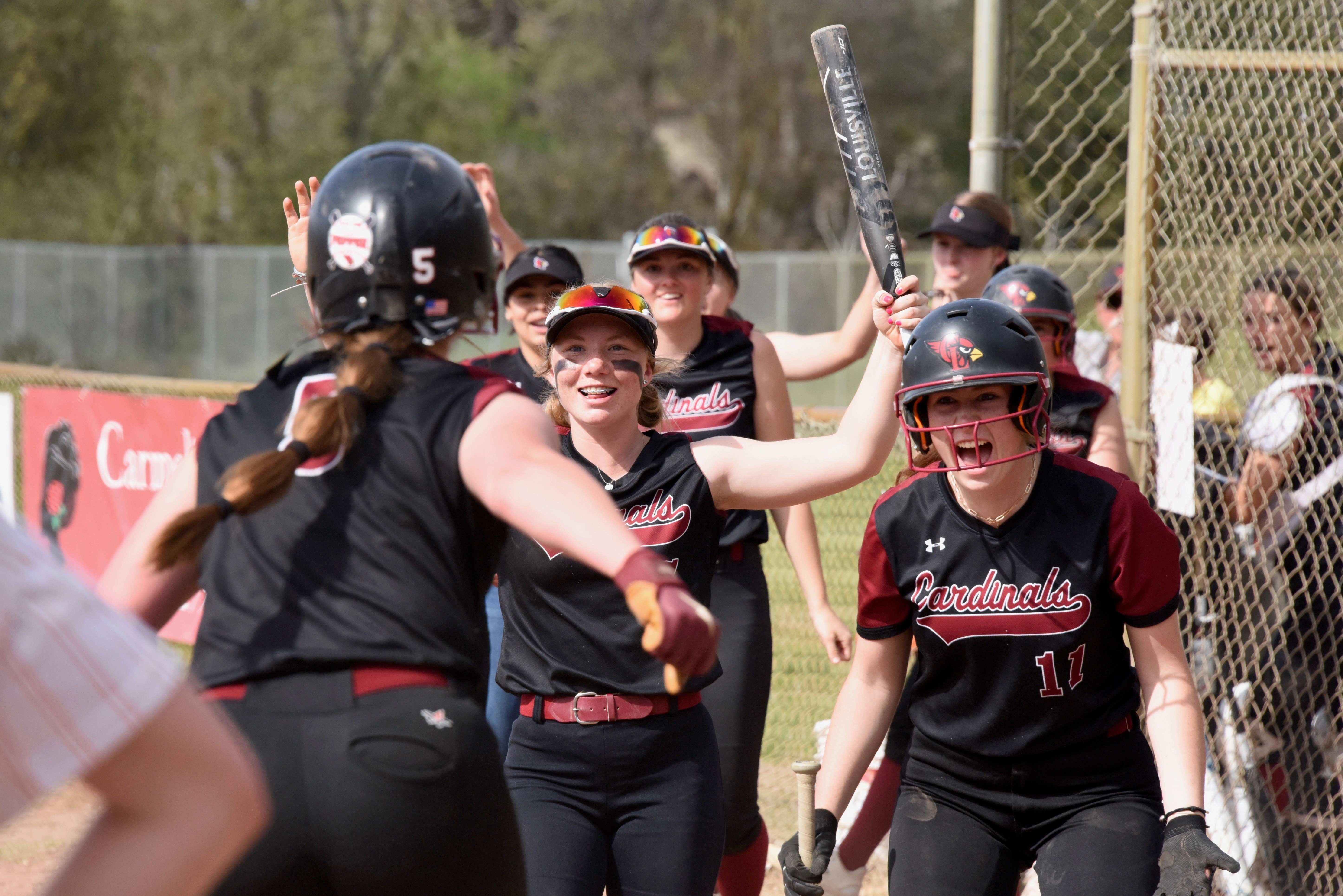 Camrin Pivniska (5) is greeted at home by her teammates, including Amber Smart and Stella Hill (11) after hitting a solo home run to center field in the top of the second inning to give Clear Lake a 1-0 lead Friday afternoon in Kelseyville. (Photos courtesy of Trett Bishop)
