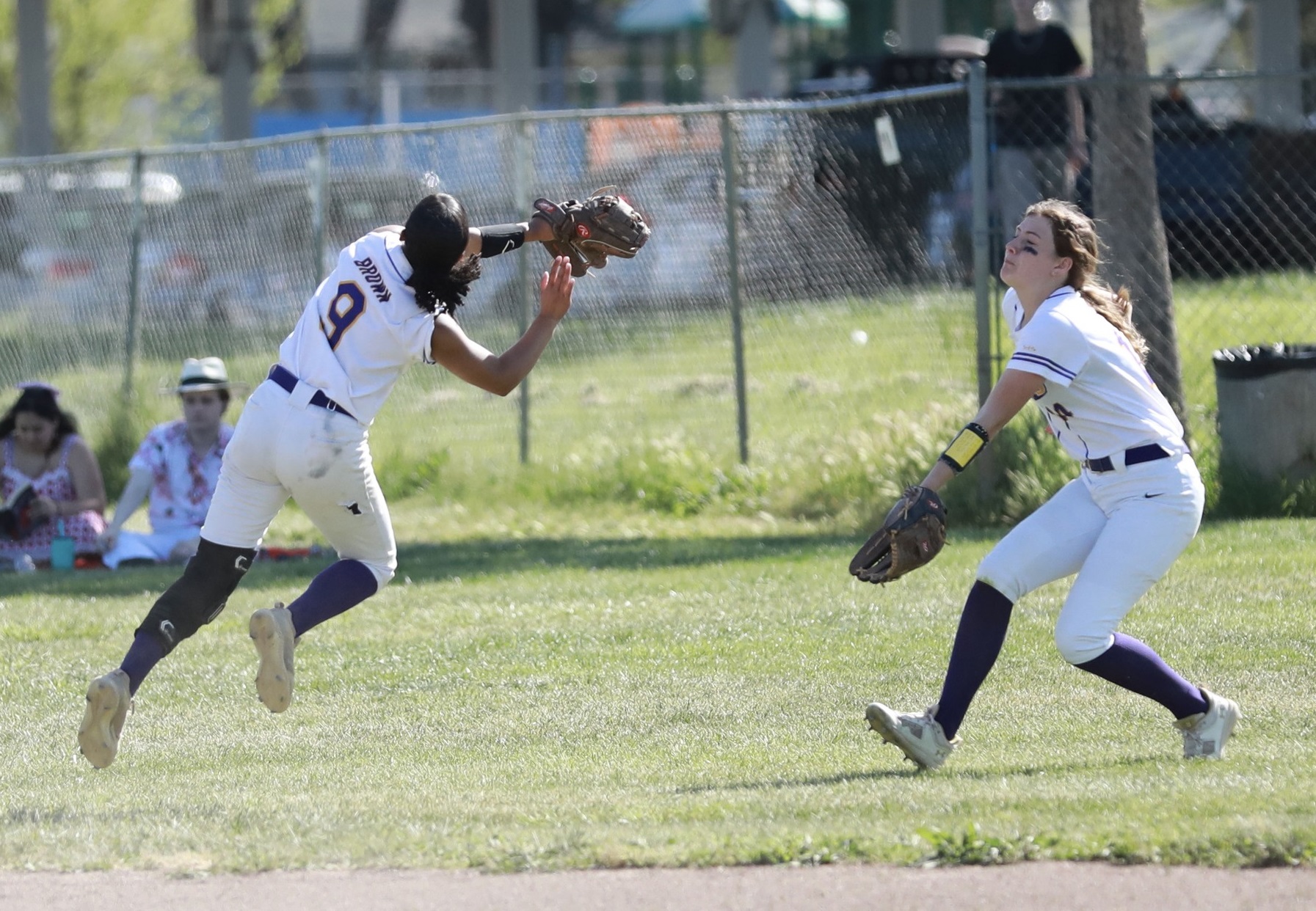 Middletown shortstop Jaidyn Brown (left) plucks a popup out of midair in front of charging outfielder Cadence Henry during the Mustangs' 11-1 league loss to St. Helena on Tuesday afternoon in Middletown. (Photo courtesy of Megan Buckley Cutting)
