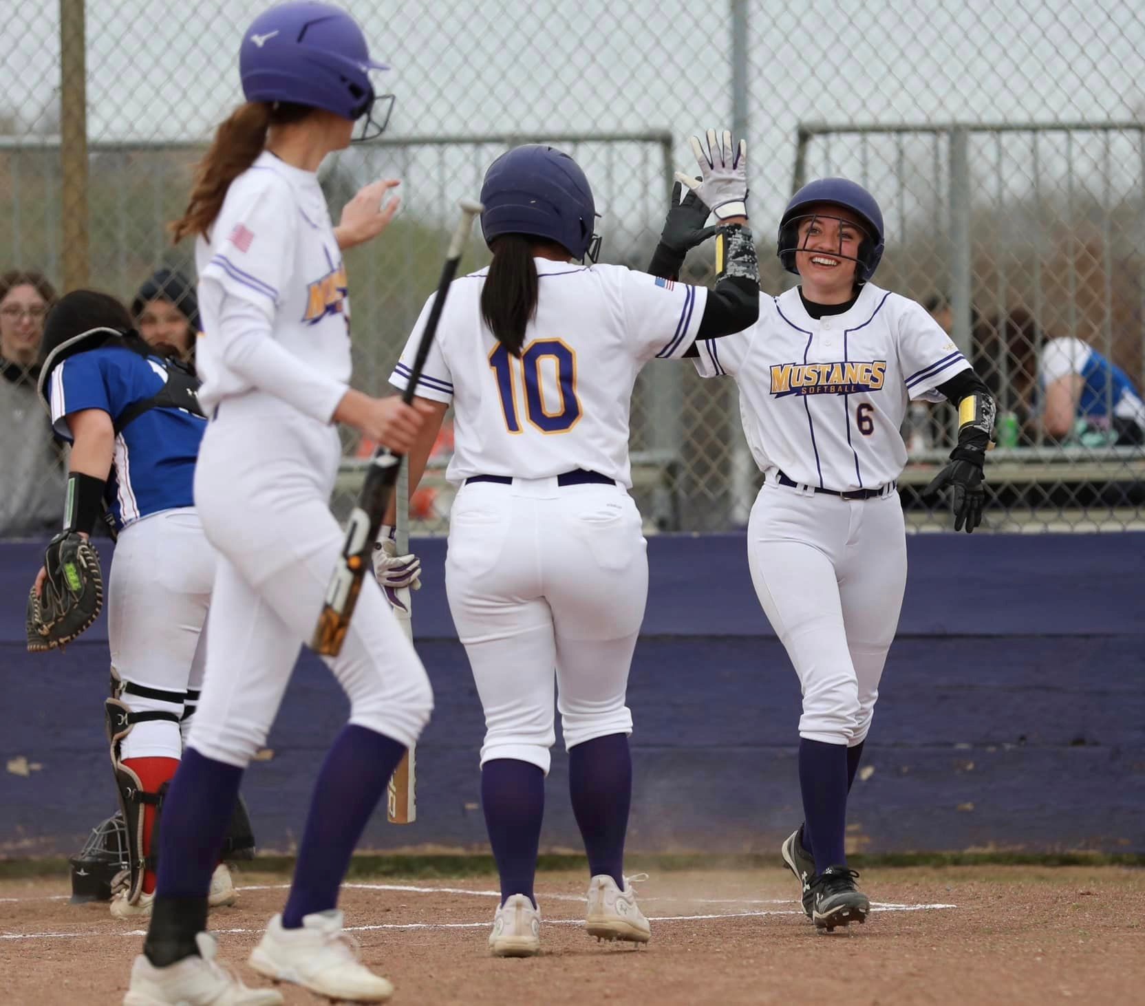 Carina Fleenor (far right) gets a high-five from teammate Breanna Pyzer after scoring a run Thursday. Fleenor went 1-for-4 with two RBIs and caught a foul popup for the game's final out in Middletown's 11-9 league win over Lower Lake. (Photos by Megan Buckley Cutting)