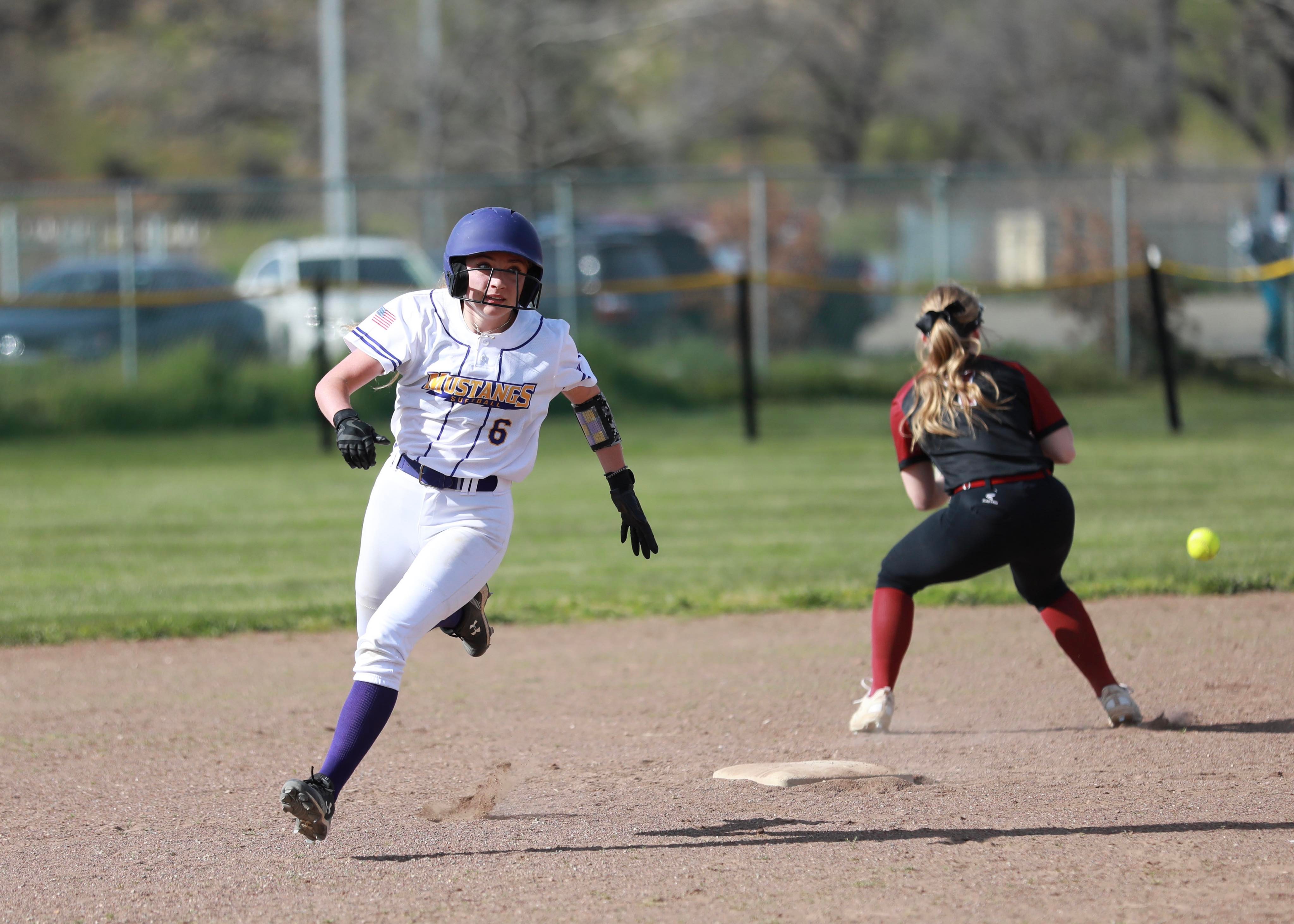 Middletown's Carina Fleenor races around second base on her RBI double in the bottom of the second inning. She thought about trying for third, hesitated and was tagged out by Clear Lake shortstop Amber Smart, who is taking the throw from the outfield. (Photos by Megan Buckley Cutting)